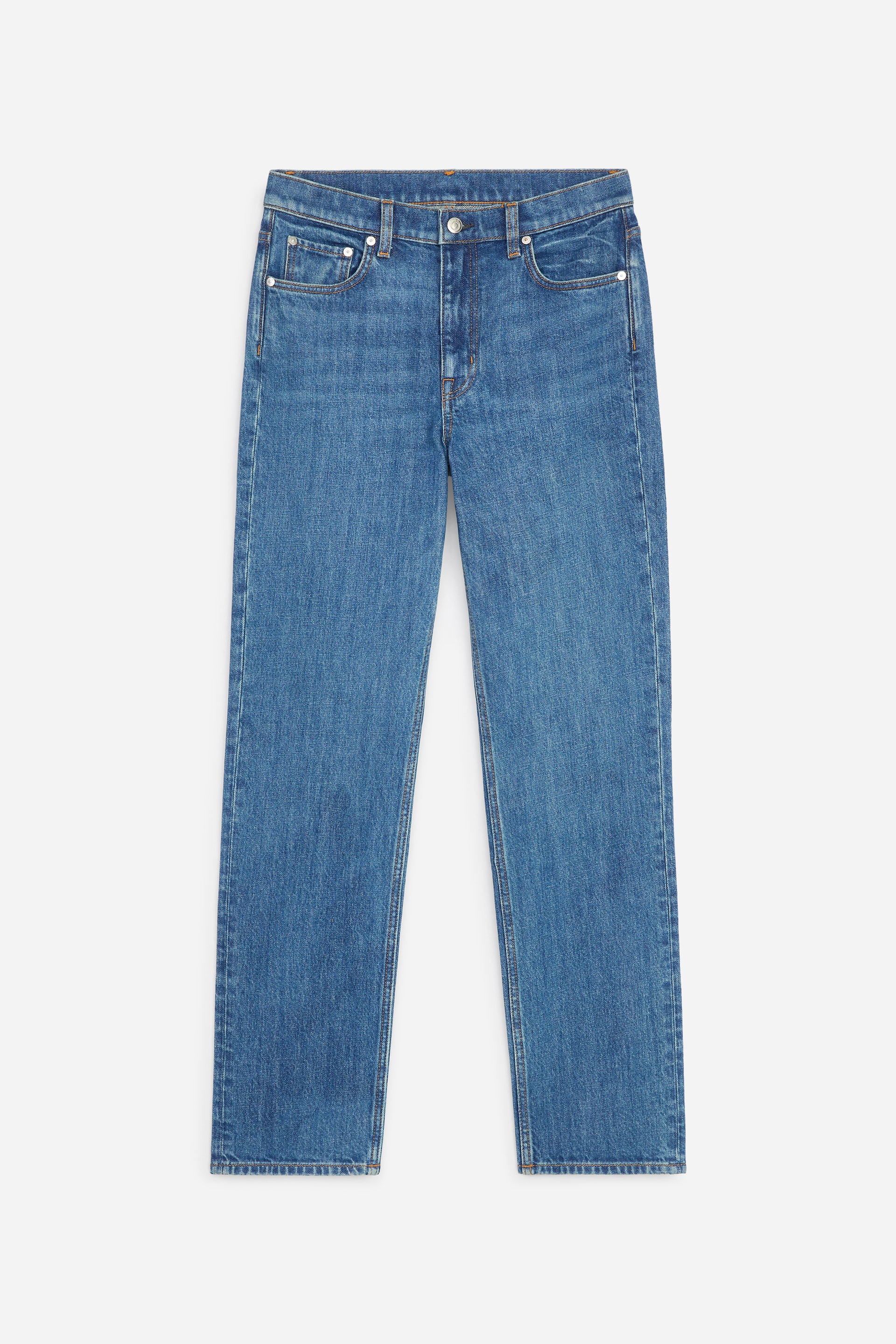 View larger image: Blue denim jeans are presented face-on, featuring a mid-rise waist, a zip fly with a single button, and front curved pockets with a coin pocket. They showcase a slim fit through the leg, tapering to full-length hems.
