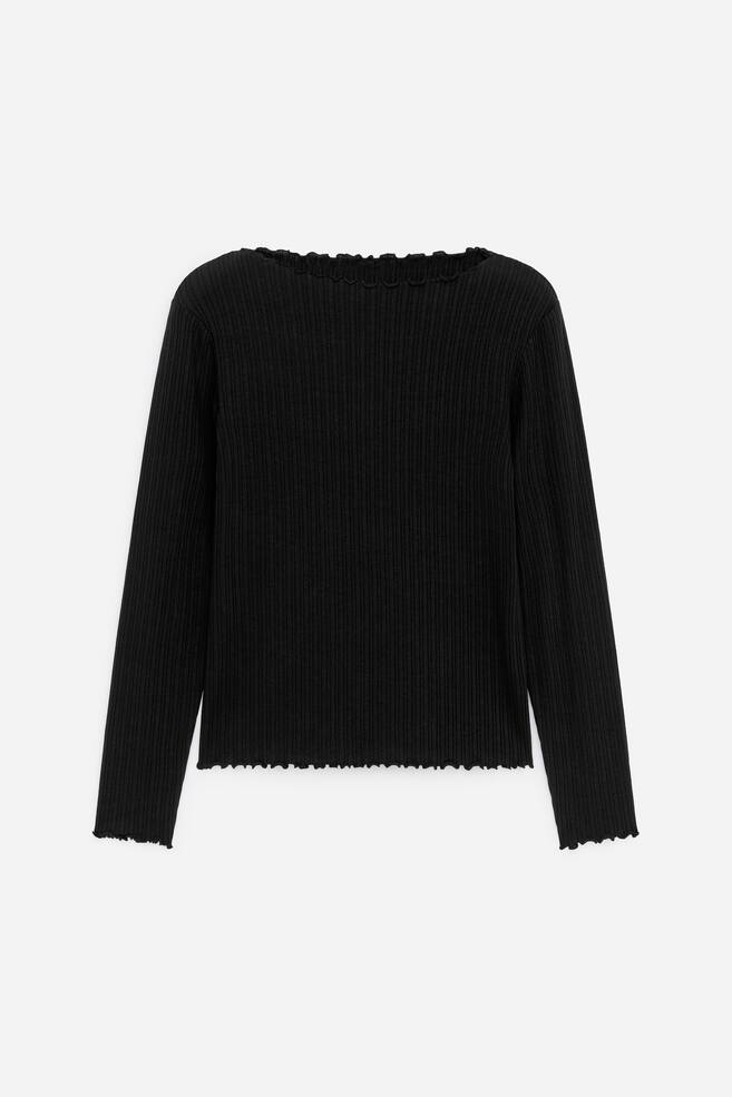A black ribbed long-sleeve top featuring a ruffled neckline, ruffled sleeve openings, and a ruffled hem, presented from the front. - 1