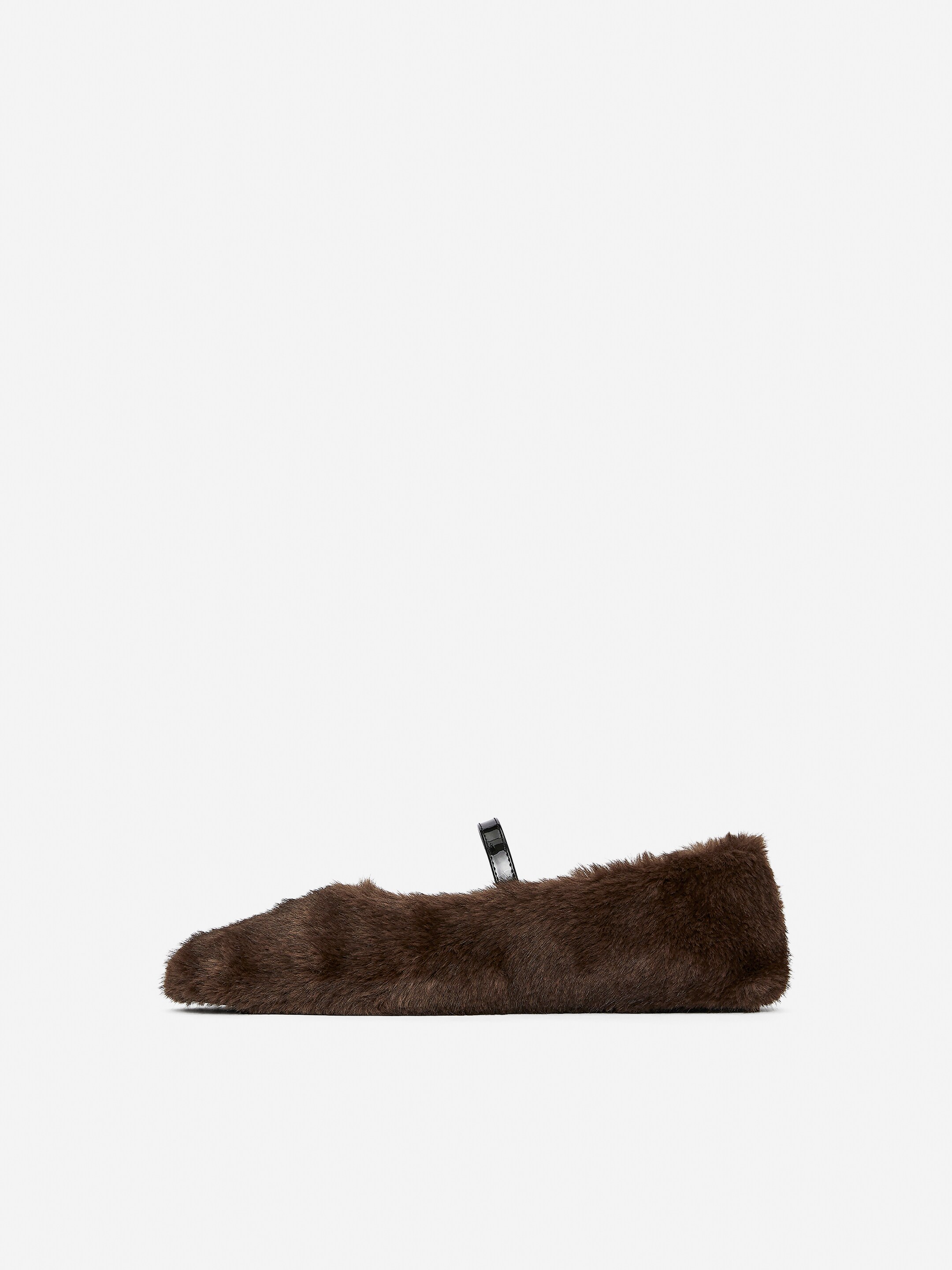View larger image: A single dark brown fur Mary Jane flat is angled to the right, featuring a pointed toe and a shiny black strap extending across the instep.
