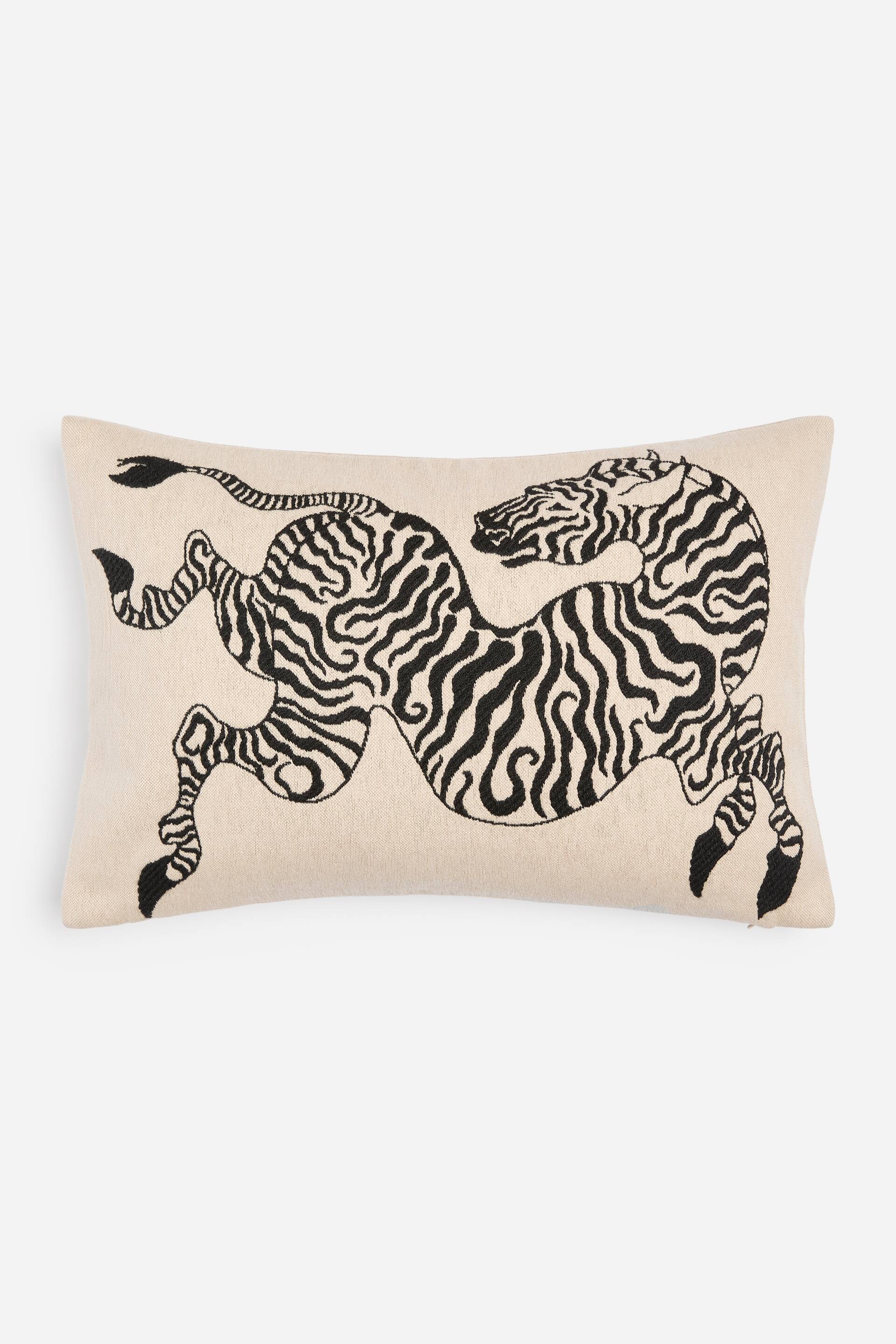 View larger image: A rectangular cushion featuring a black embroidered stylised zebra design, depicting a running zebra, on a light beige fabric.
