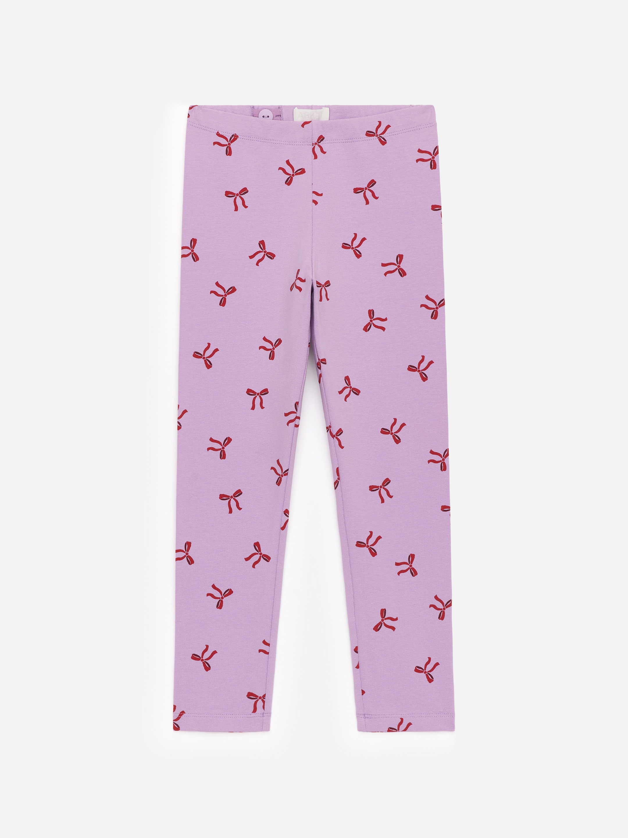 View larger image: FRONT view of light purple leggings, cut from soft single jersey fabric, featuring a repeating pattern of small red bows. The leggings are designed with an elasticated waist that includes adjustable elastics visible on the inside.