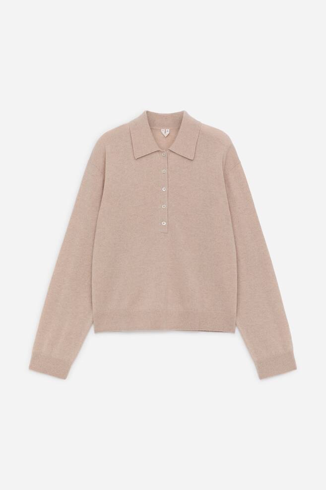 A soft-textured, beige knitted polo shirt is showcasing its FRONT, featuring a classic polo collar and a five-button placket. It displays long sleeves with ribbed cuffs and a ribbed hem, maintaining a regular fit. - 1