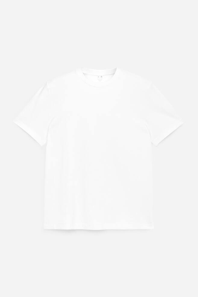 Un tricou alb este prezentat din față. Are guler rotund, mâneci scurte și o textură netedă a materialului. - 1