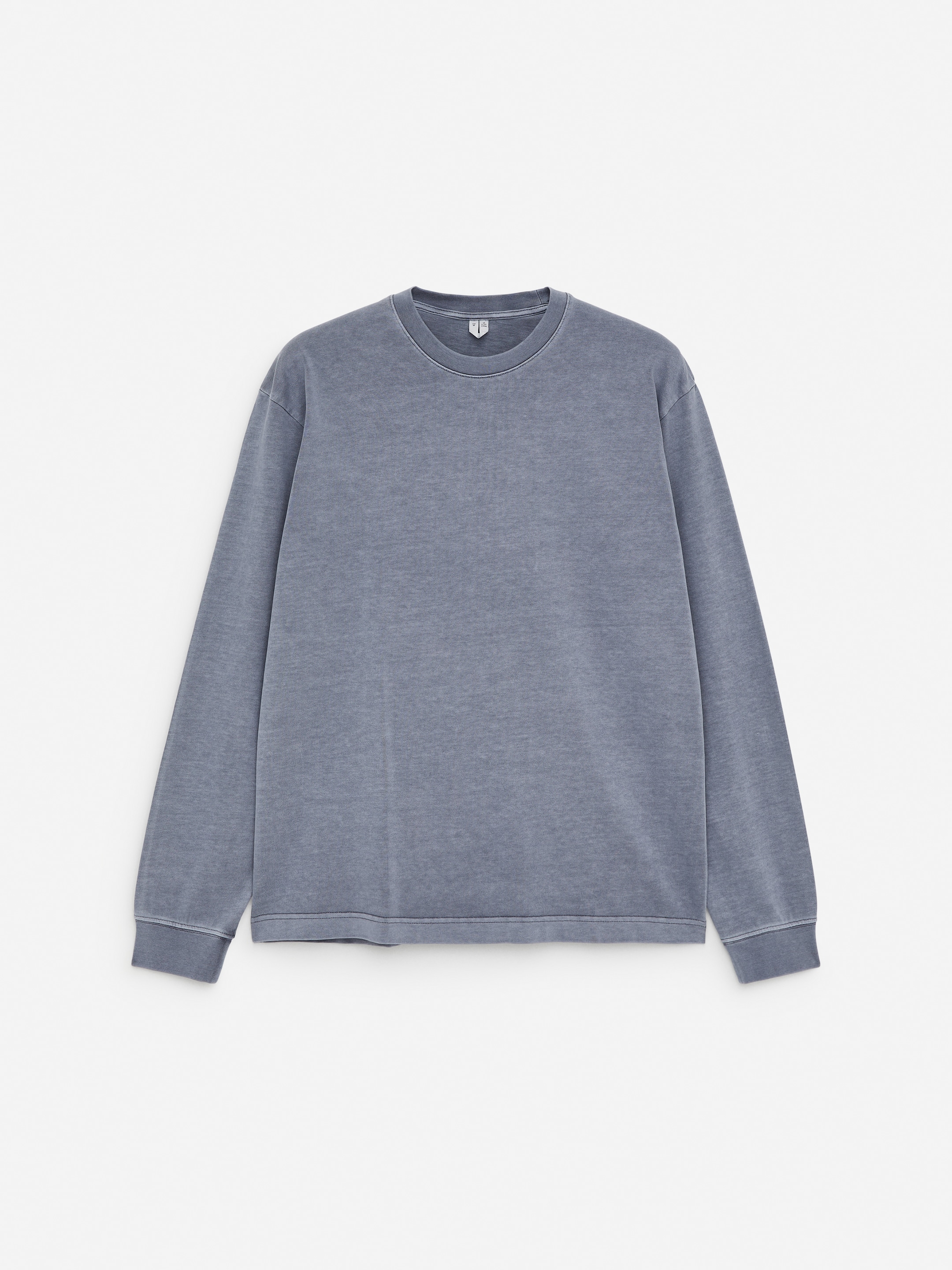 View larger image: A long-sleeved t-shirt is being displayed from the front, crafted from a faded blue-gray cotton fabric. It is featuring a classic crew neck and ribbed cuffs on the sleeves.
