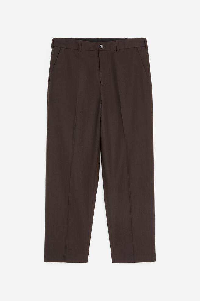 A pair of dark brown trousers is shown from the front, featuring a structured waistband with belt loops, a single-button fastening, and slanted side pockets. The straight, relaxed-fit legs display sharp pressed creases running down the centre. - 1