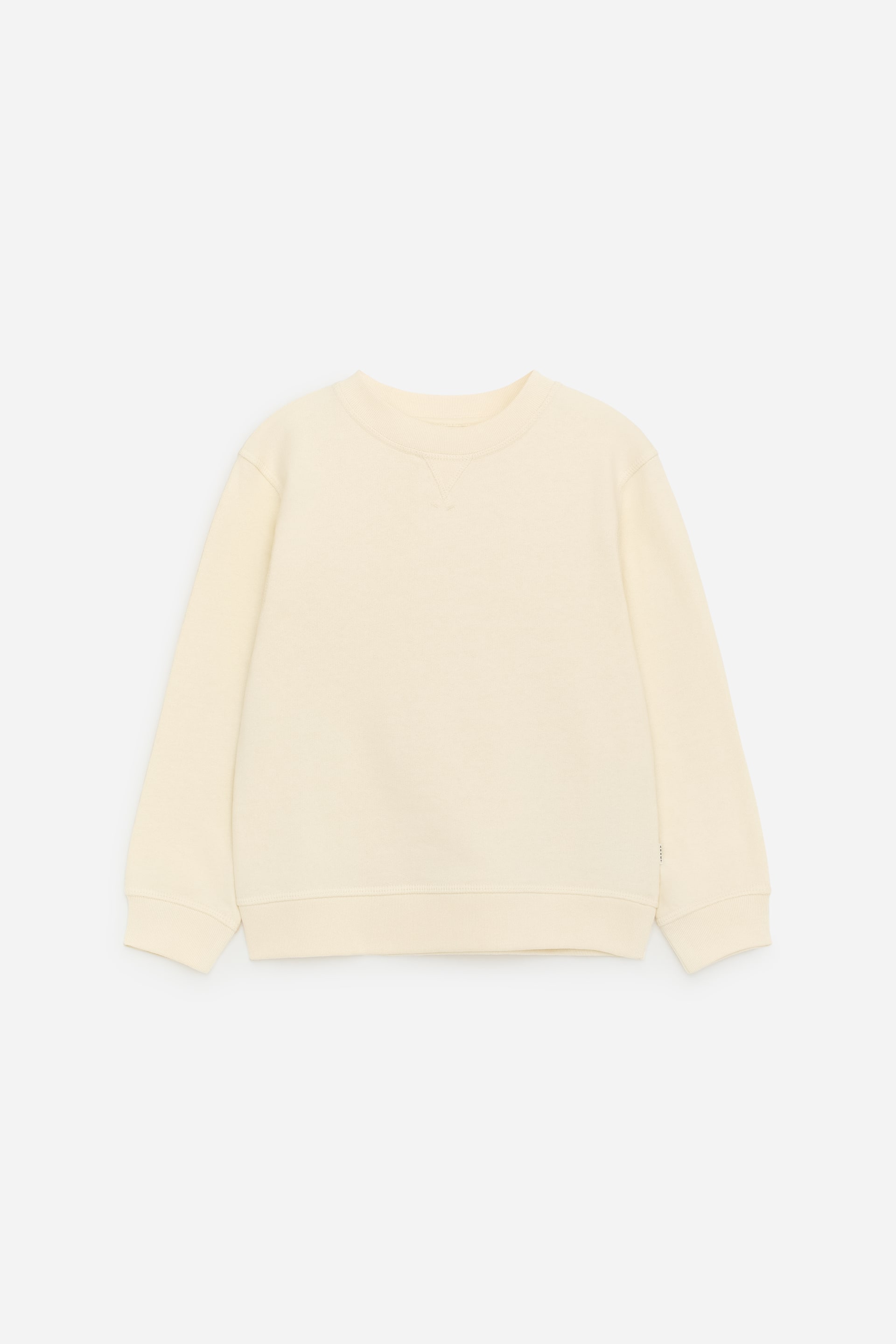 Ver imagen más grande: Una sudadera de color crema se muestra de frente, con un cuello redondo y detalle de costura en V, mangas largas con puños acanalados y un dobladillo acanalado.