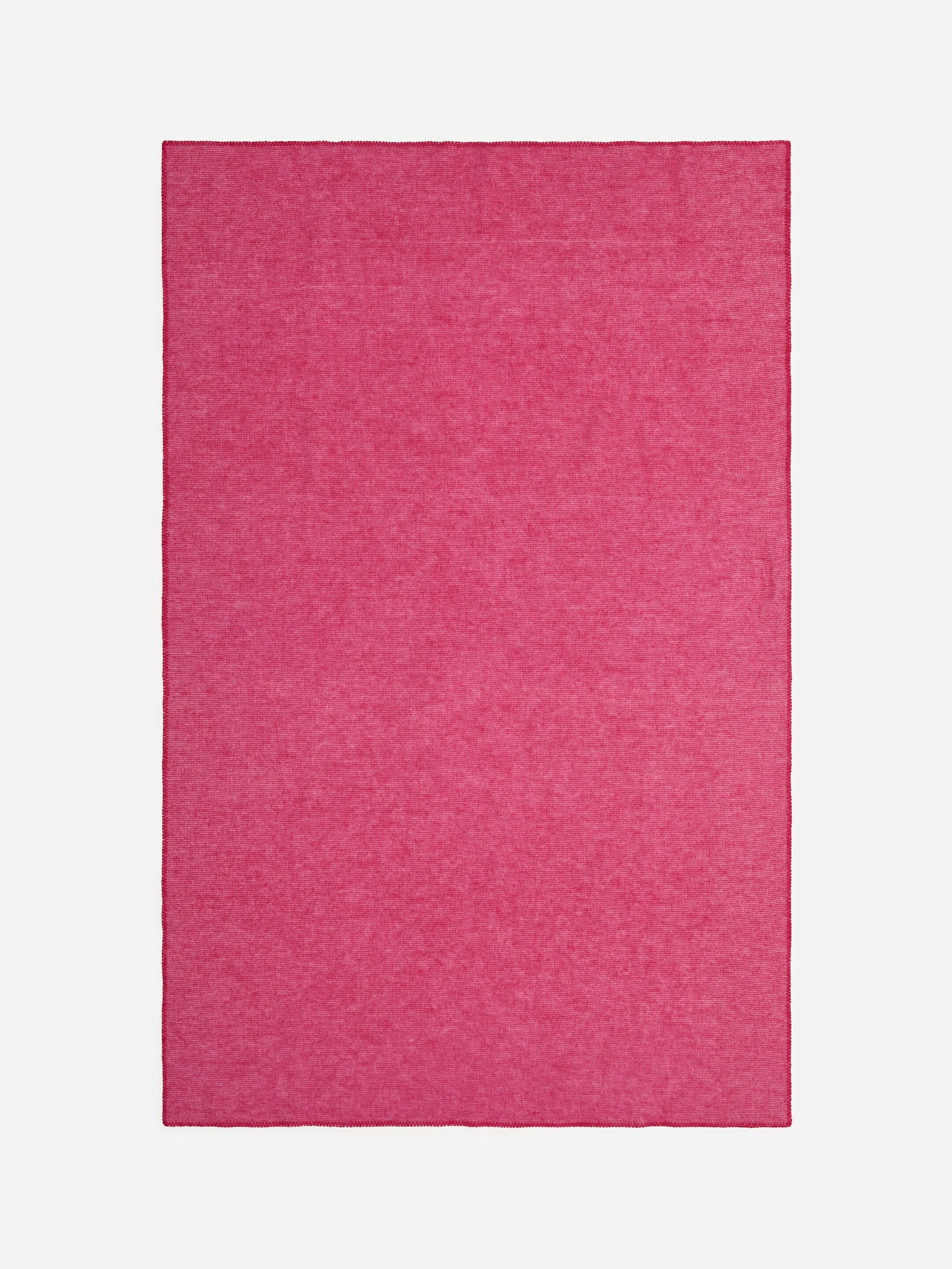 View larger image: A rectangular blanket is presenting flat, showcasing a solid magenta color with a finely textured surface. Blanket stitching is edging all four sides of the 200 cm x 130 cm product.