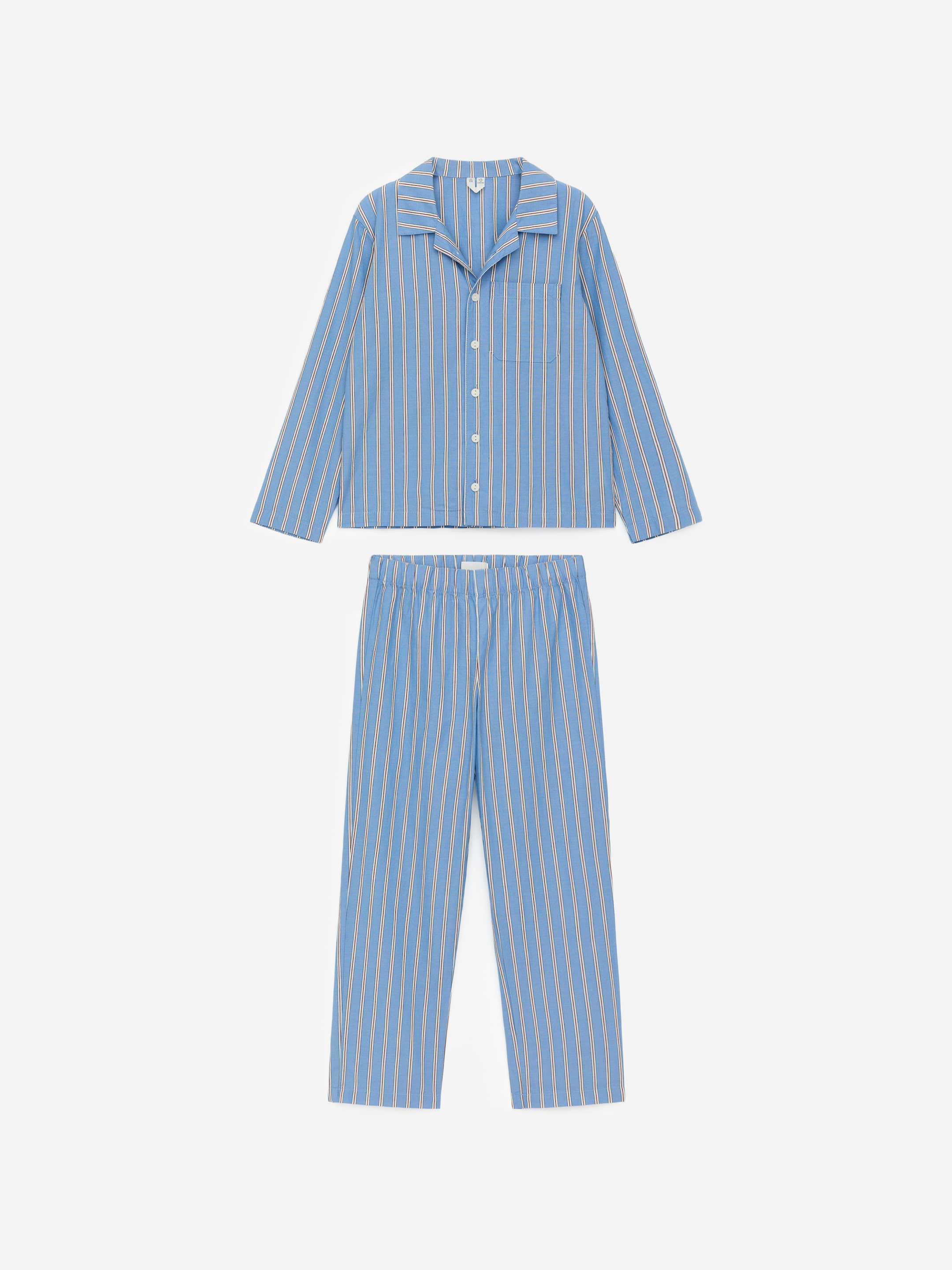 View larger image: A pyjama set, patterned with blue and white vertical stripes, is shown in a front view. It features a long-sleeved shirt with a revere collar, a button-up closure, and a single chest pocket, while the matching trousers are displaying an elasticated waist.