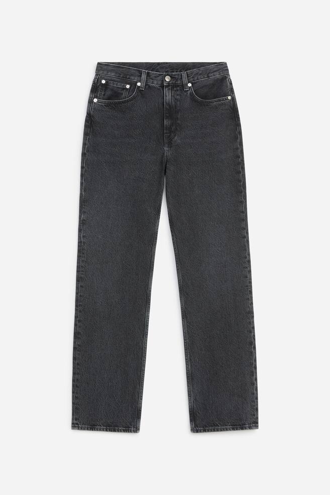 A pair of faded black straight-leg jeans is shown from the front, featuring a mid-rise waist, classic five-pocket styling, and silver-tone metal rivets. - 1