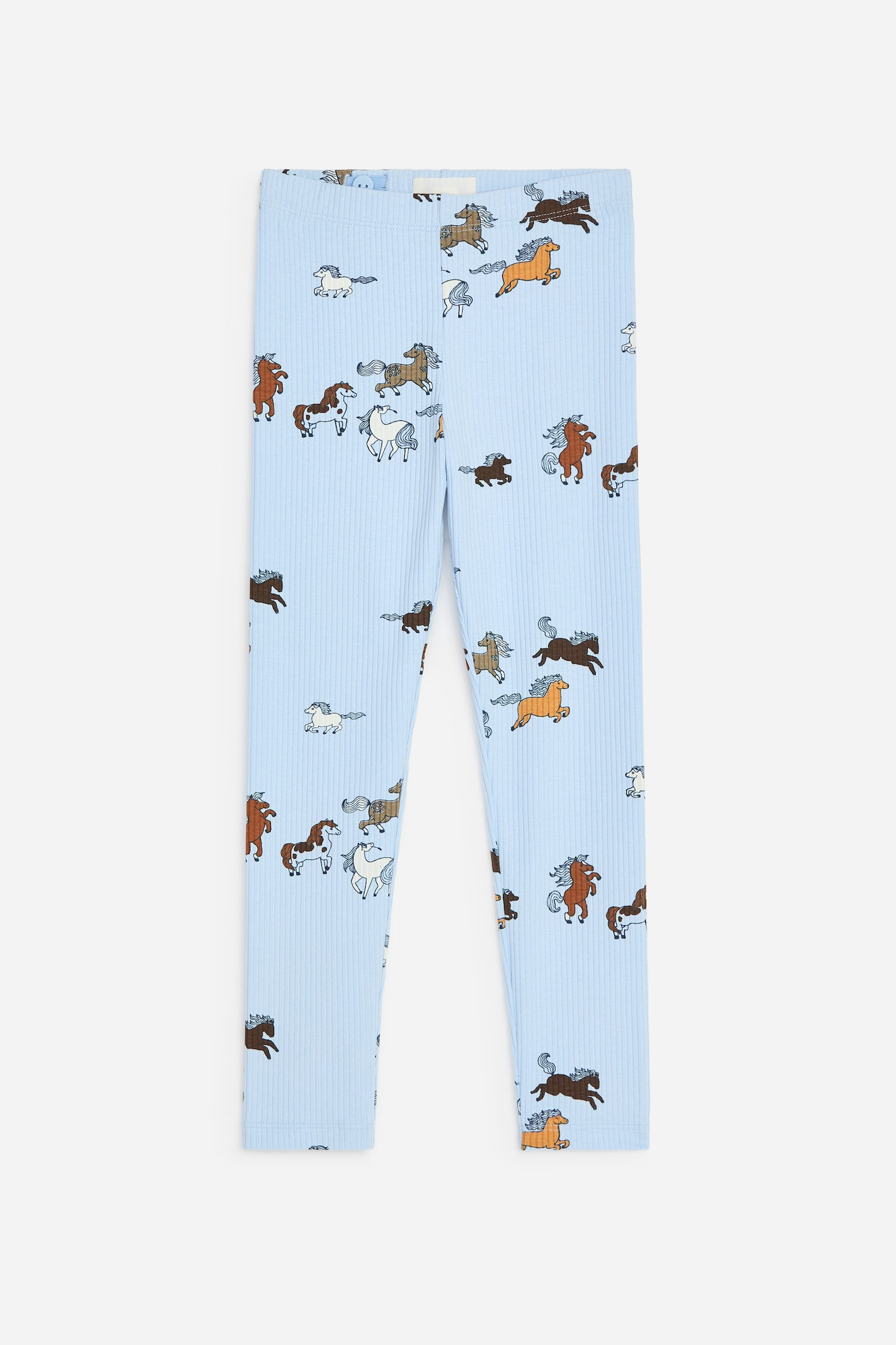 Questi leggings a costine azzurri sono mostrati frontalmente e mettono in evidenza una stampa all-over di cavalli in vari colori e in pose dinamiche. I leggings presentano una vita elasticizzata e un design slim fit a lunghezza intera.