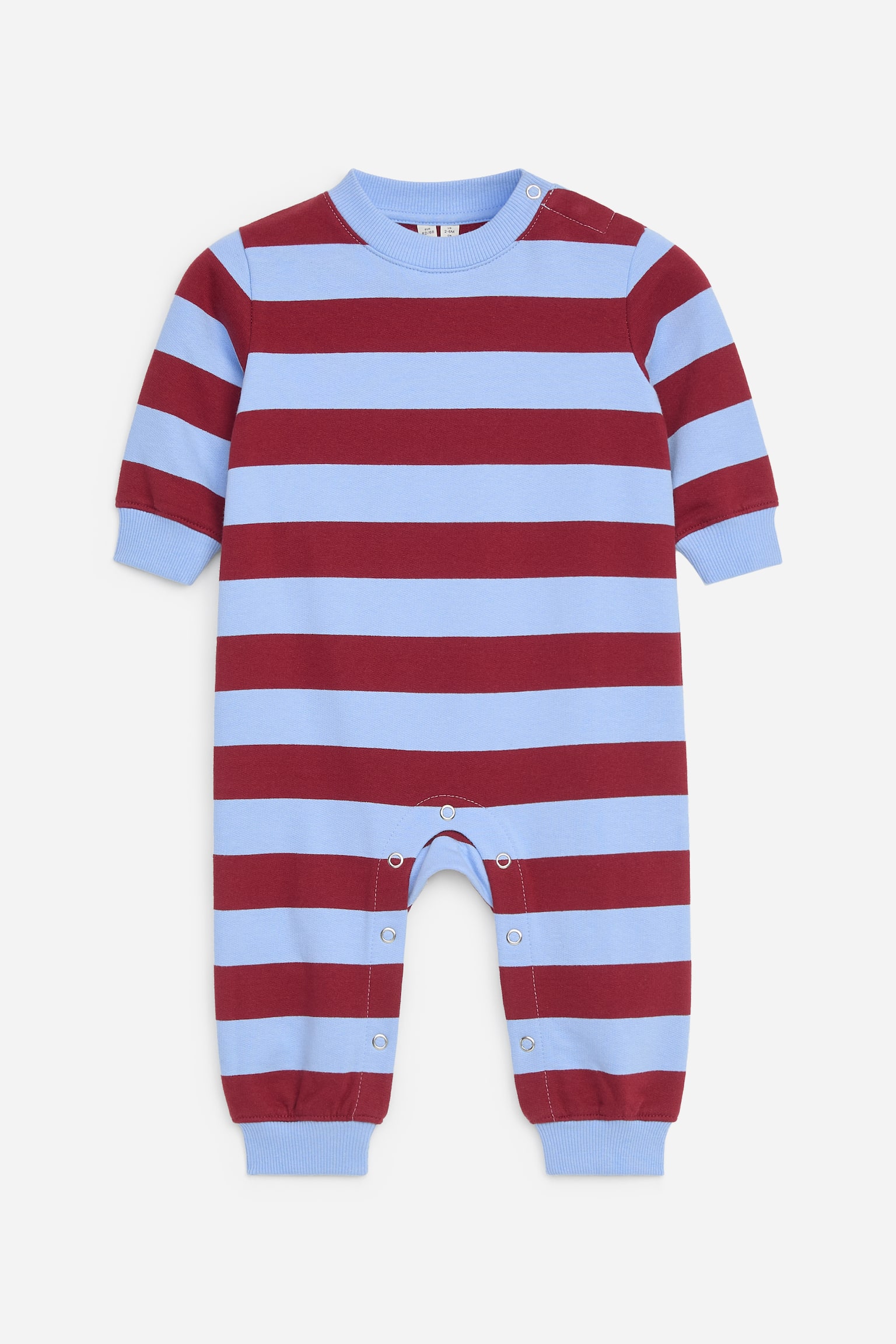A long-sleeved baby all-in-one is shown from the front, featuring horizontal stripes in light blue and maroon. The design includes a ribbed crew neck, ribbed cuffs at the sleeves and legs, and snap button fastenings at the shoulder and along the inner leg seam.