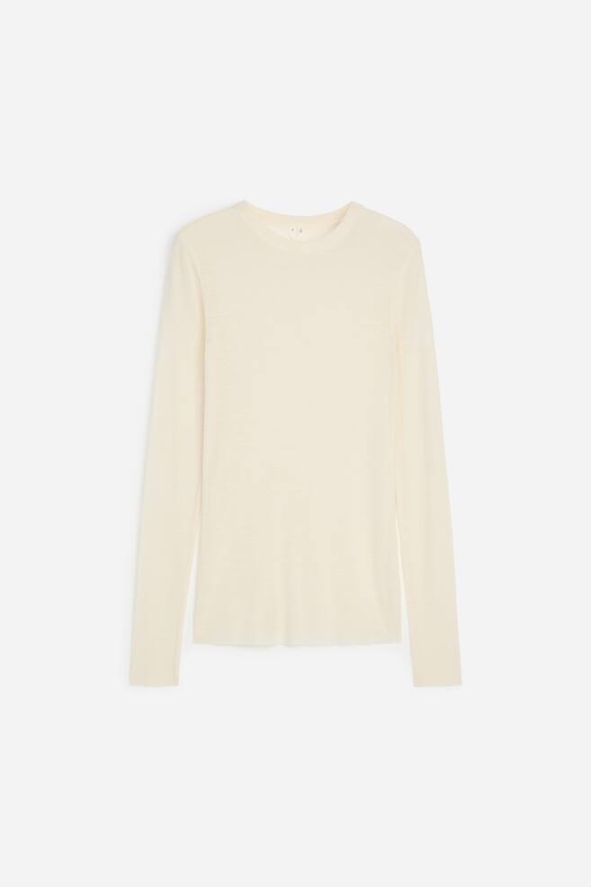 A cream-coloured, long-sleeve knit top is facing front, showcasing a crew neck with a ribbed collar, long fitted sleeves, and a straight hem in a lightweight, fine-knit texture. - 1