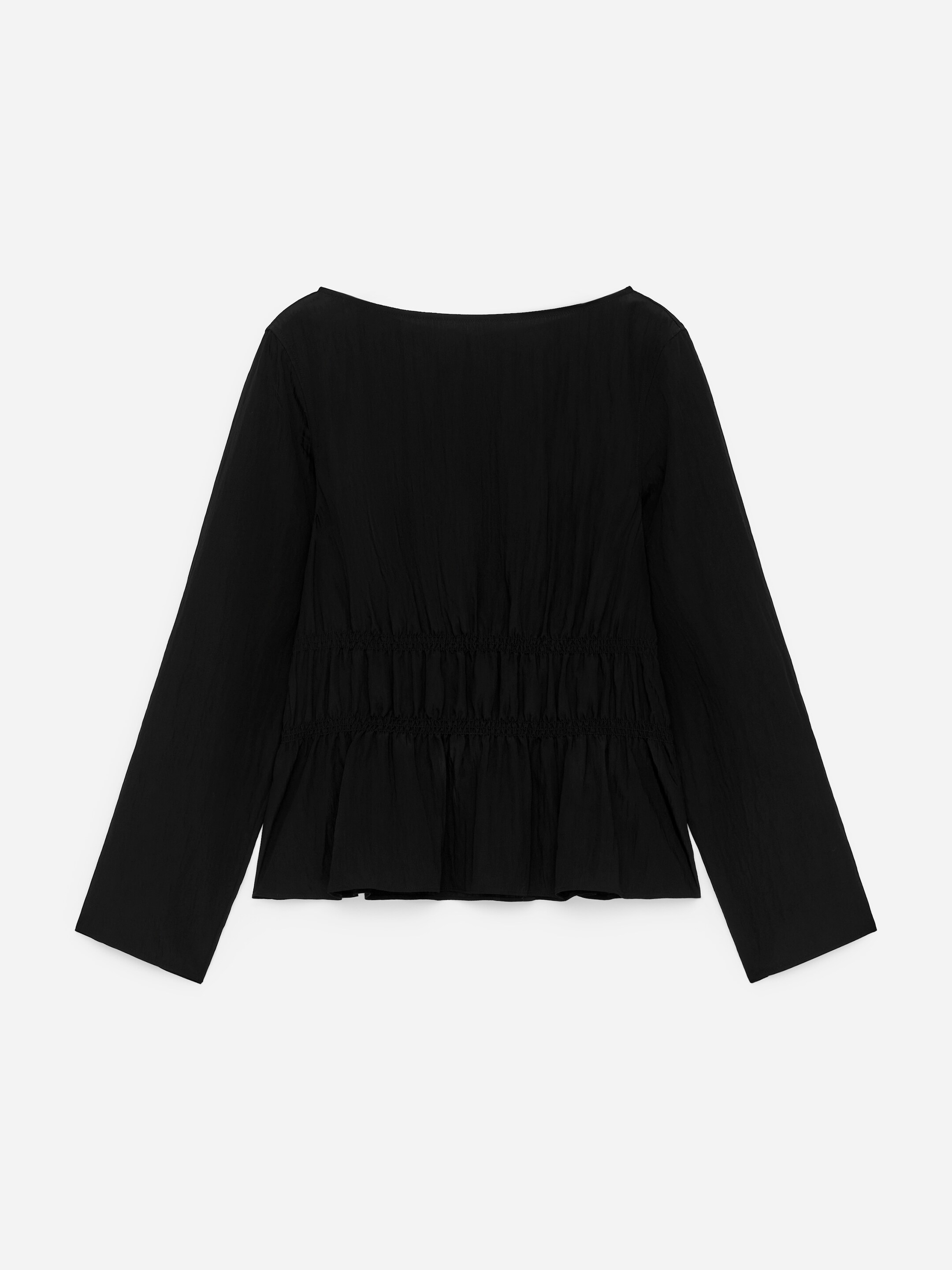 View larger image: A black top is featuring a wide boat neckline and long sleeves, presented from the FRONT. The mid-section is detailed with horizontal shirring, creating a gathered waist and a subtly flared bottom.