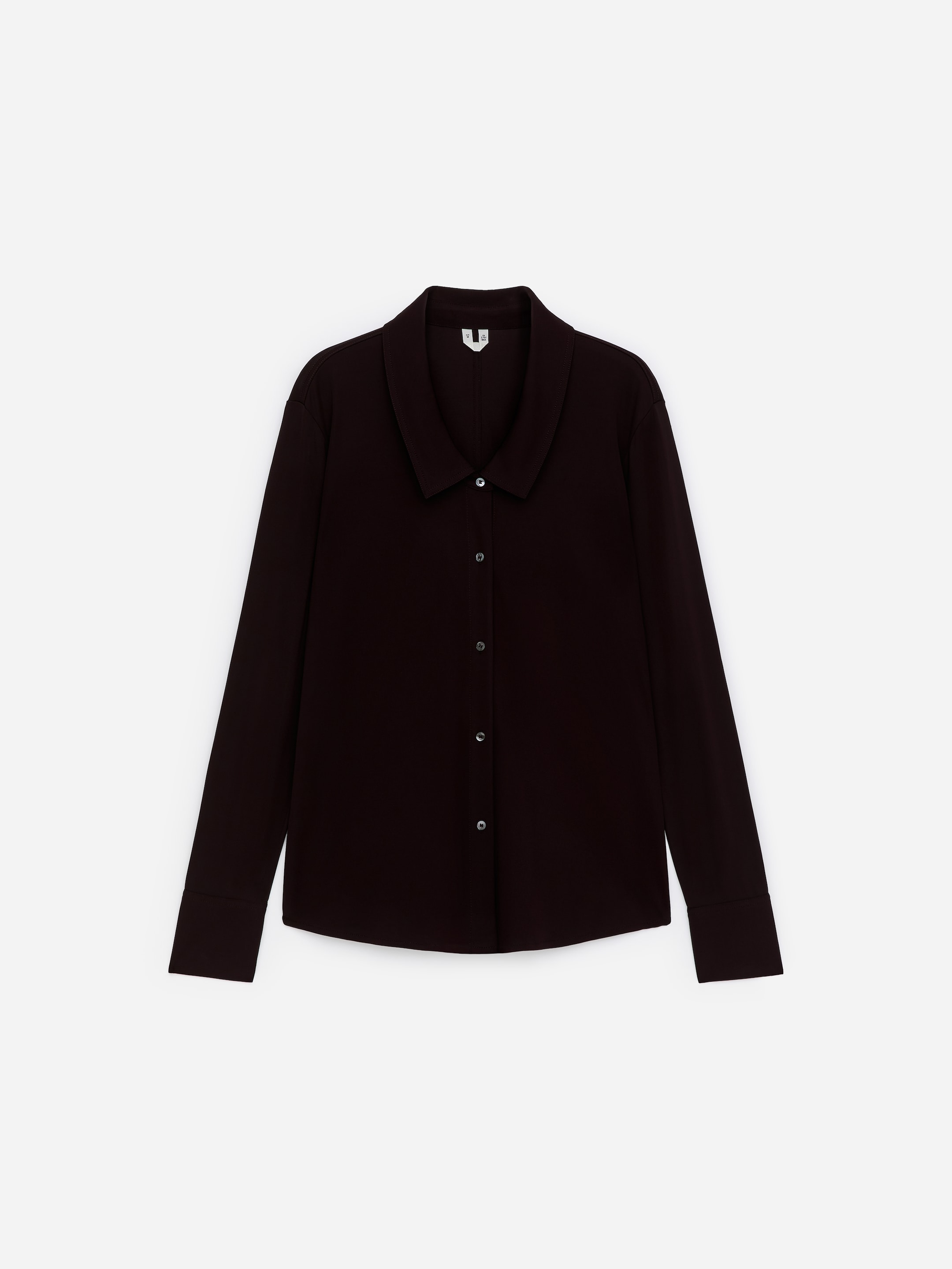 Agrandir l'image: Une chemise marron foncé à manches longues est orientée vers l'avant, avec un col évasé. Une patte de boutonnage complète descend le long du devant, fixée avec des boutons de couleur claire, et les manches longues se terminent par des poignets larges.