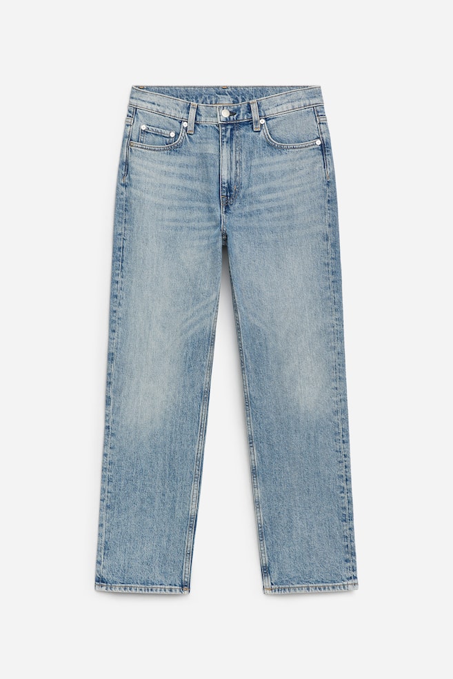 A pair of light to medium blue denim jeans is presenting FRONT, featuring a mid-rise waist, a slim silhouette, and tapered cropped legs, with a silver-toned button fastening, belt loops, five-pocket styling, and subtle fading on the thighs. - 1