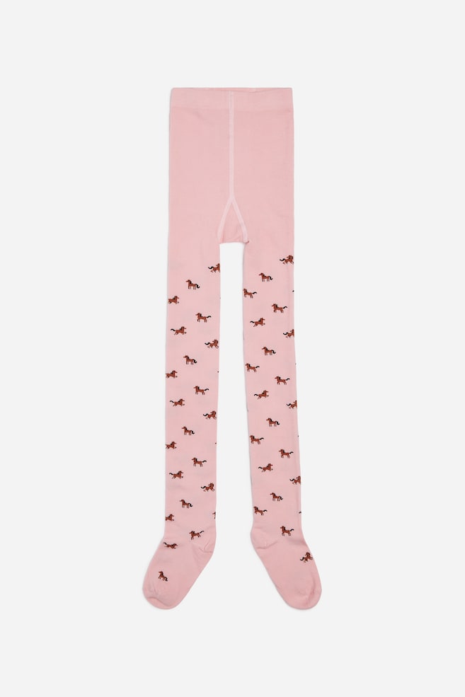 Frontansicht einer hellrosa Strumpfhose aus Baumwollmischung mit einem allover Muster aus kleinen braunen Pferden, mit breitem elastischem Bund und geformten Füssen. - 1