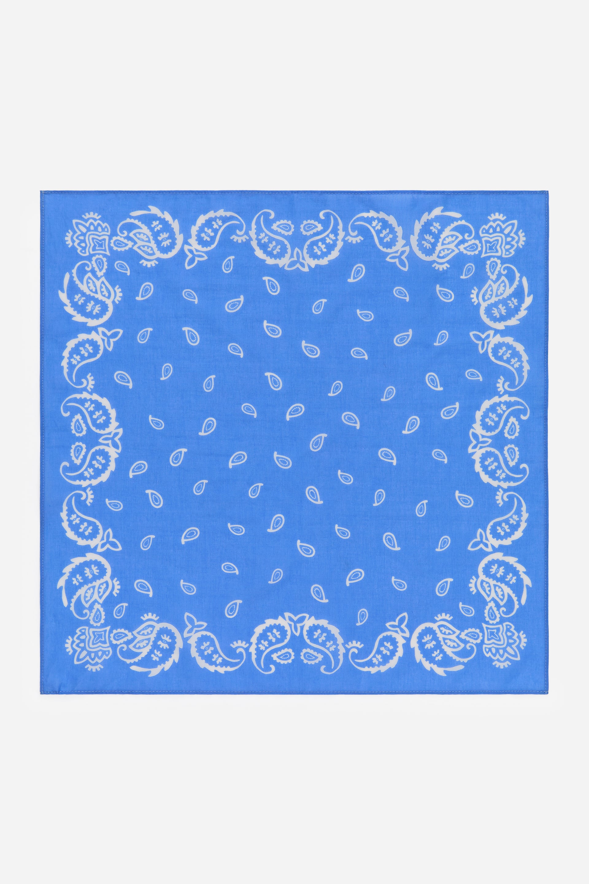 View larger image: A classic square bandana, FRONT, crafted from soft blue cotton, showcases a white paisley pattern with an ornate border and scattered smaller motifs across its 45 cm x 45 cm surface.