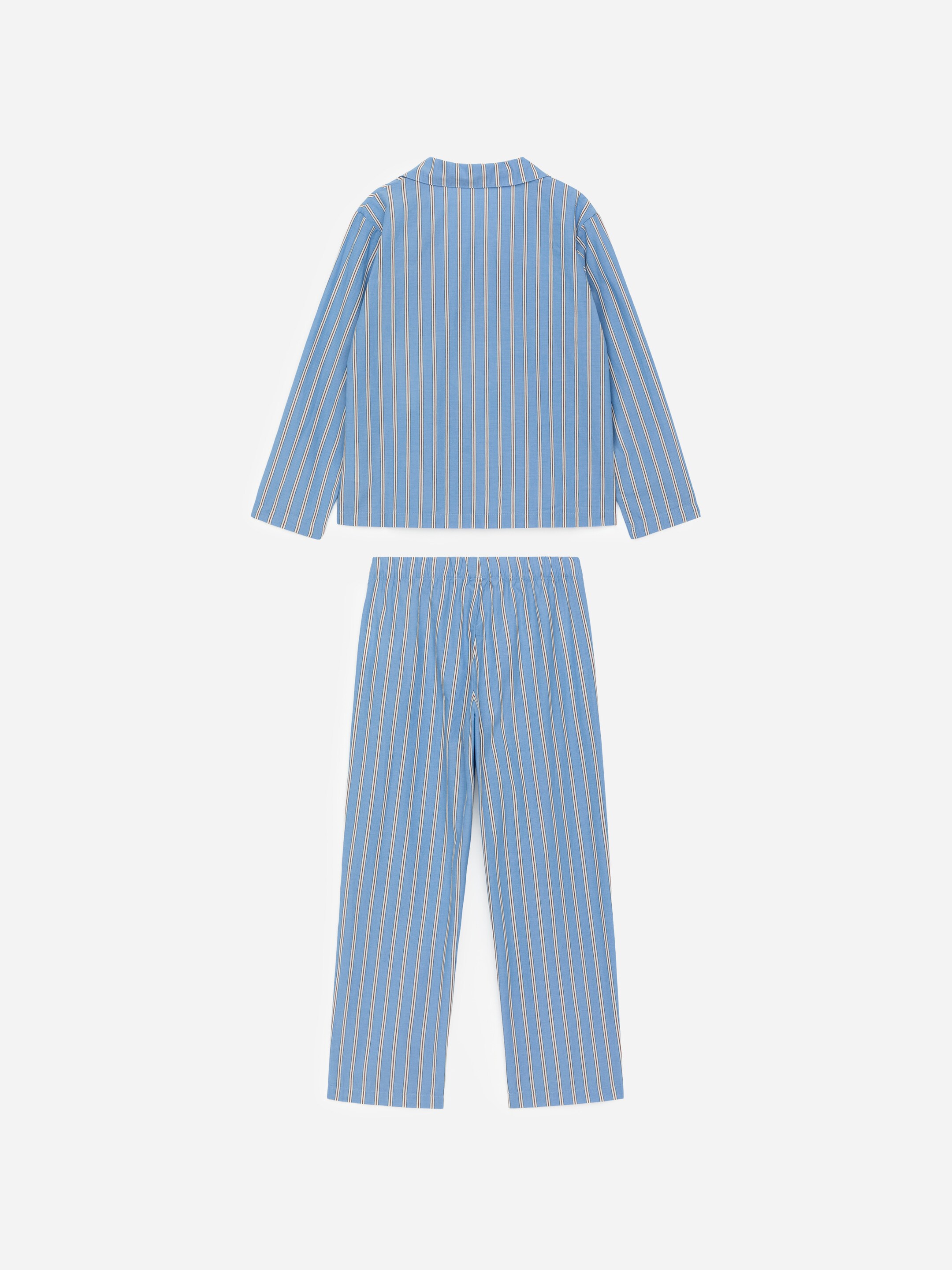 View larger image: A pyjama set in blue and white vertical stripes is being presented, showing the back of a long-sleeved shirt and matching trousers. The shirt is featuring a folded collar, and the trousers are displaying an elasticated waist.