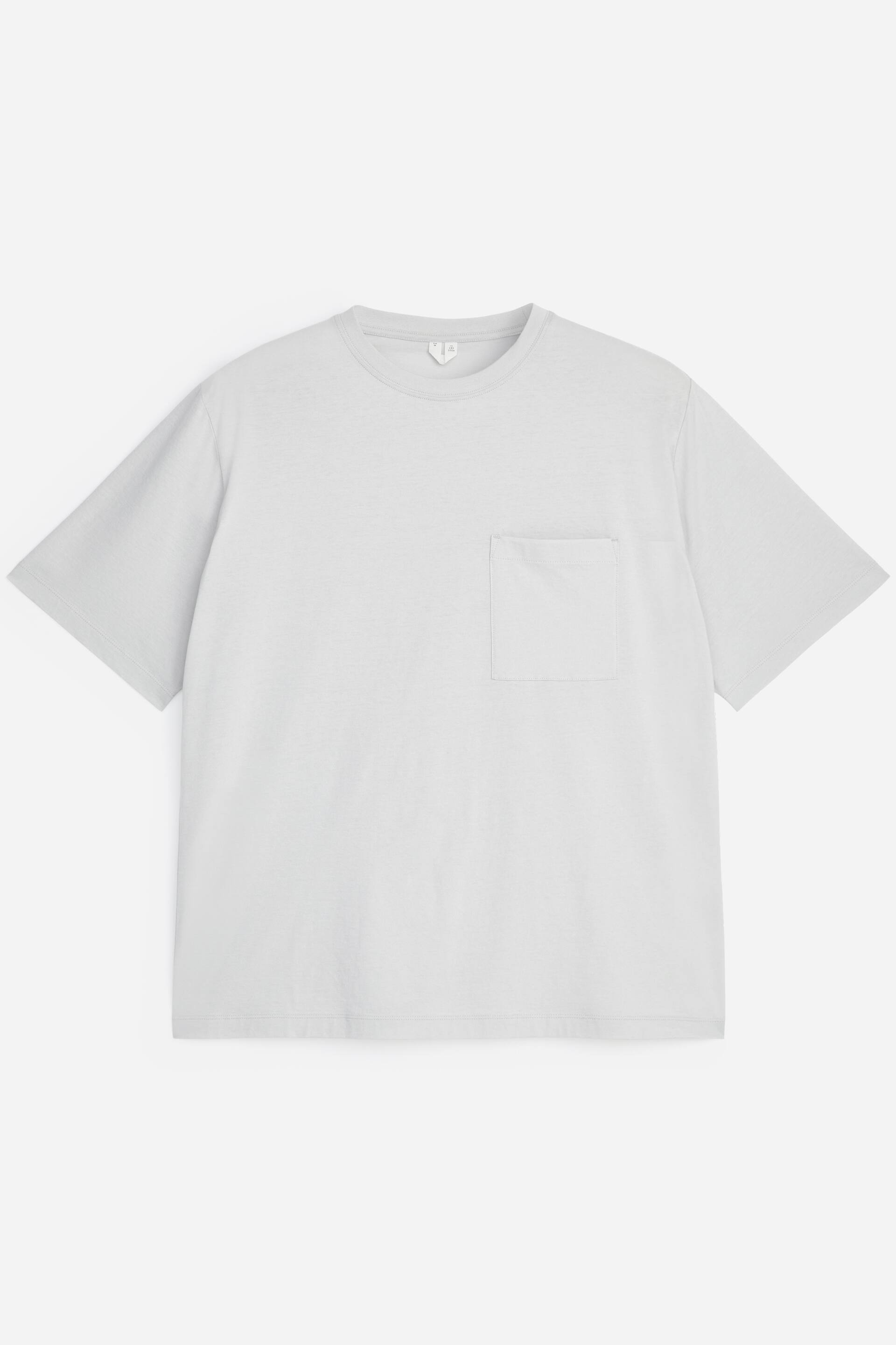 Zobrazit větší obrázek: Světle šedé tričko s krátkým rukávem má zepředu uvolněný střih. Je vybaveno kulatým výstřihem s žebrovaným lemováním a jednou náprsní kapsou na levé straně hrudi.