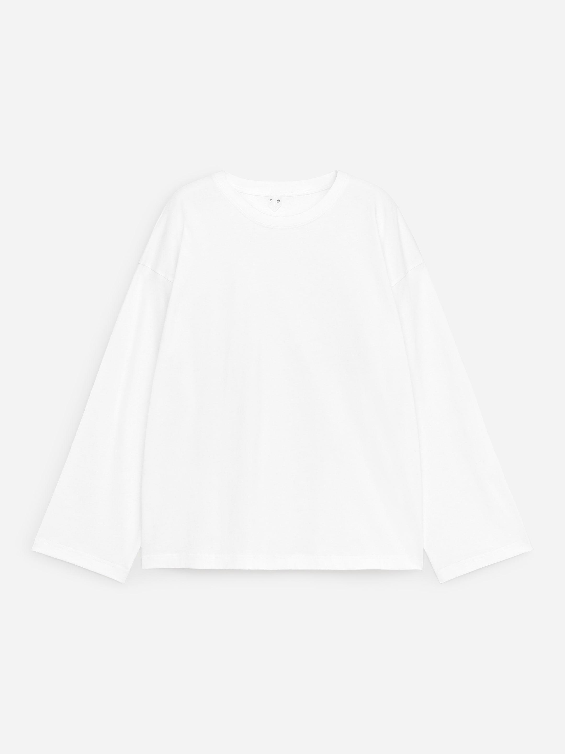 View larger image: A white oversized long-sleeved T-shirt is shown from the front, featuring a crew neck, wide sleeves with straight cuffs and a relaxed silhouette.