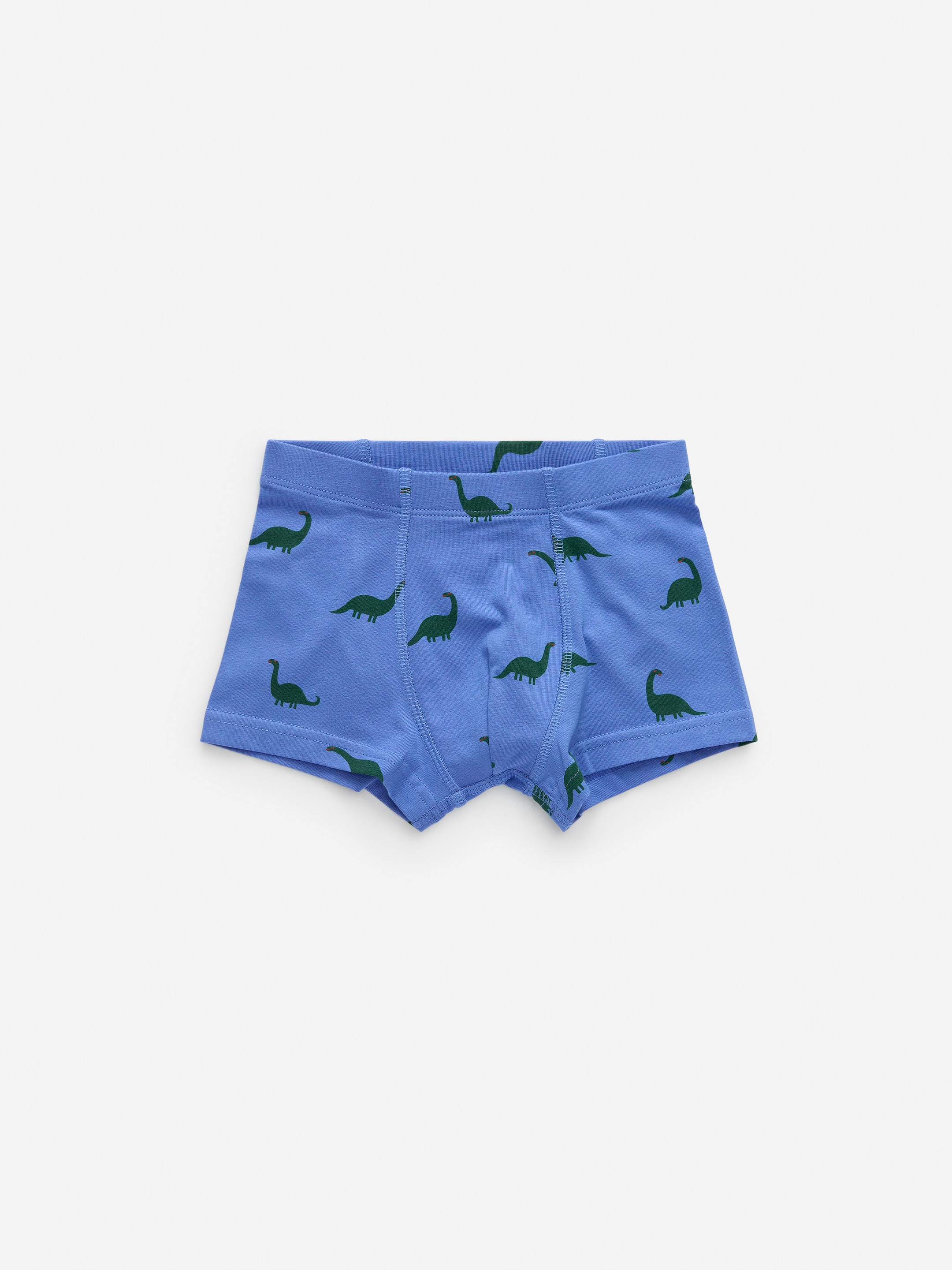 Größeres Bild anzeigen: Blaue Single-Jersey-Boxershorts zeigen ein sich wiederholendes Muster von grünen Dinosaurier-Silhouetten. Die VORDERSEITE der Boxershorts verfügt über einen elastischen Bund und eine gefütterte Vorderseite.