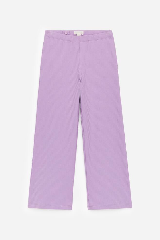 Light purple wide trousers are being presented from the front, featuring a rib-knitted structure and an interior waistband with visible buttons for adjustable elastics. - 1