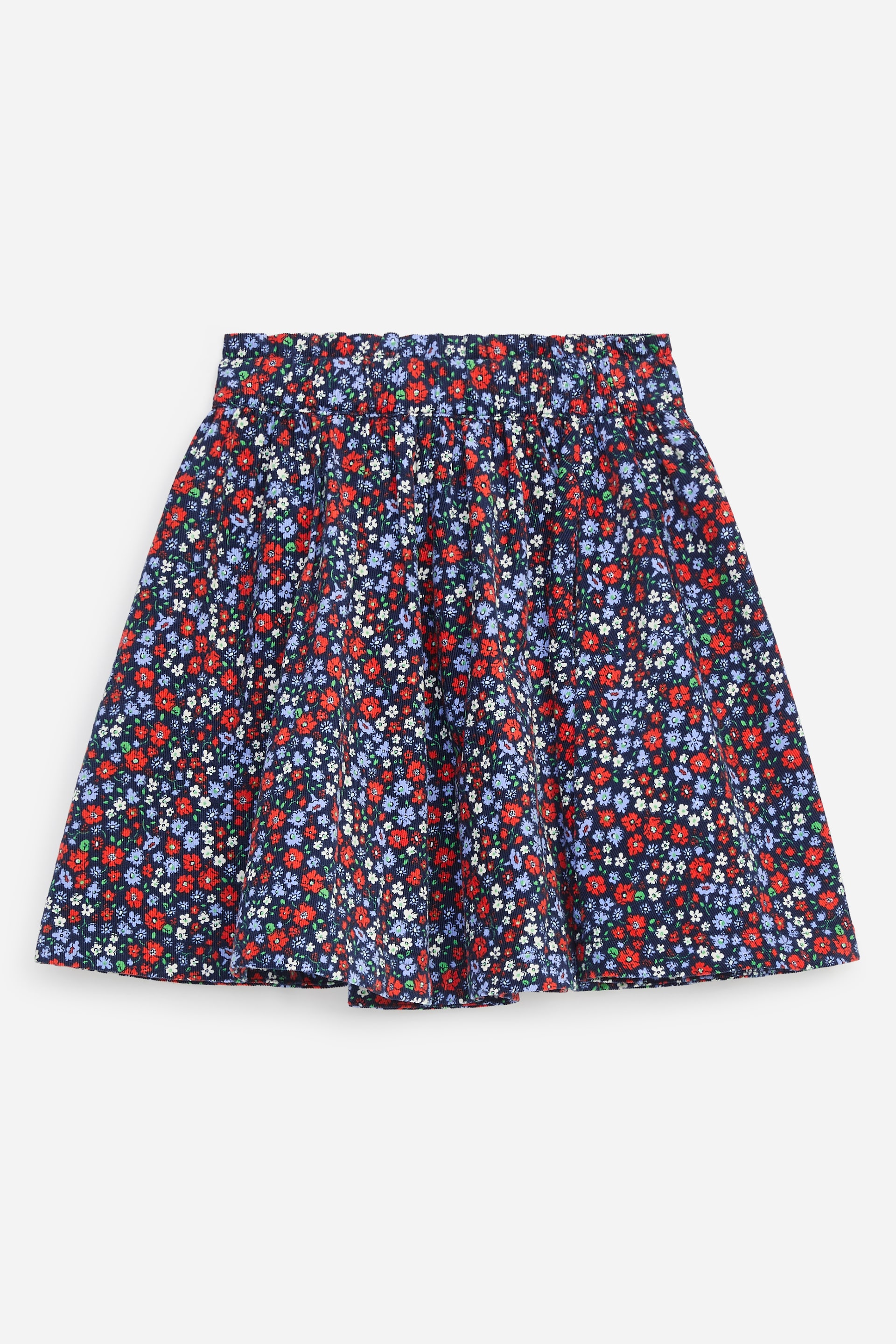 Agrandir l'image: Une jupe en velours côtelé pour bébé, longueur genou, est présentée de face, avec une silhouette évasée volumineuse et un imprimé floral miniature intégral en rouge, bleu et blanc. La jupe met en valeur une taille élastiquée froncée avec un bord supérieur à volants.