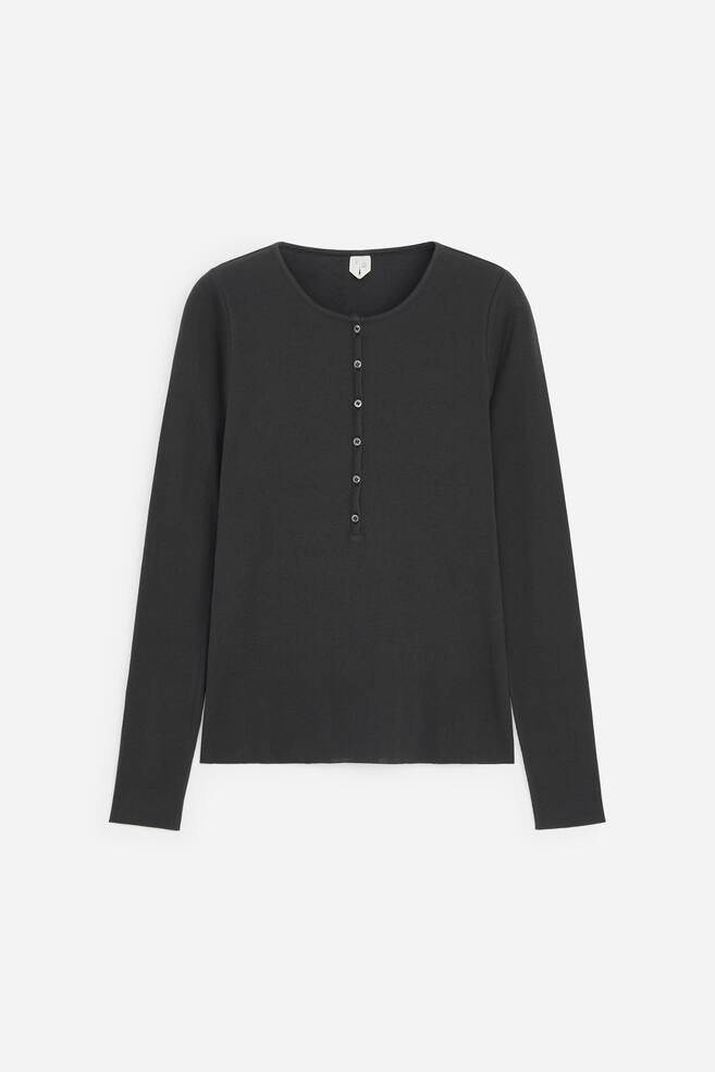 A charcoal grey long-sleeved Henley shirt is shown from the front, featuring a round neckline and a partial button placket with six small matching buttons. The shirt presents a straight-cut silhouette with long sleeves and a clean, straight hem. - 1