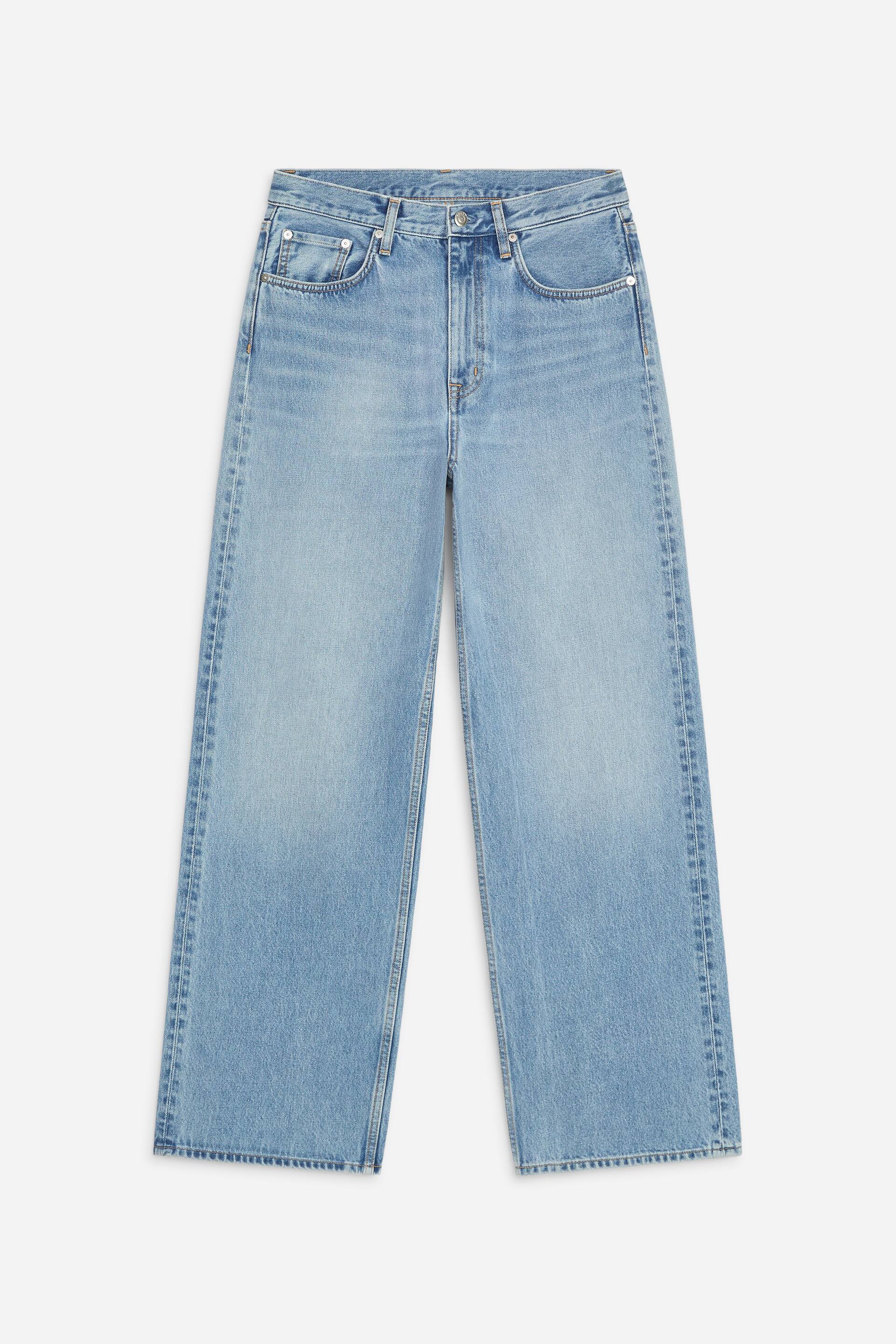 Grösseres Bild ansehen: Hellblaue Denim-Hosen werden von vorne präsentiert, mit hoher Taille, lockerer Passform und weitem Bein. Der helle Jeansstoff zeigt subtile Ausbleichungen, und die Hosen verfügen über Gürtelschlaufen, klassisches Fünf-Taschen-Design mit Nieten sowie Knopf- und Reissverschluss.