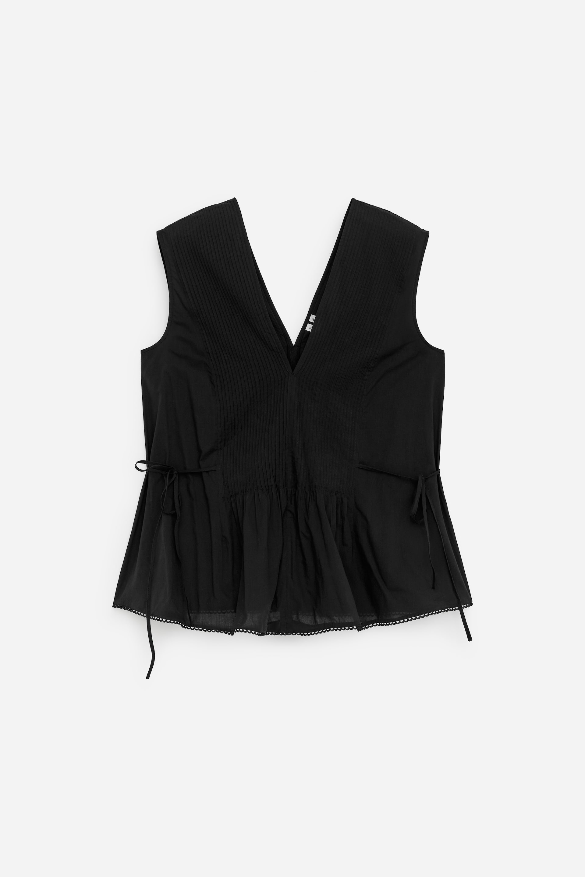 View larger image: A black sleeveless top is presenting its FRONT, featuring a V-neckline and vertical pintucks detailing the bodice. It is showcasing a gathered peplum hem with side tie details and a scalloped trim along the bottom edge.