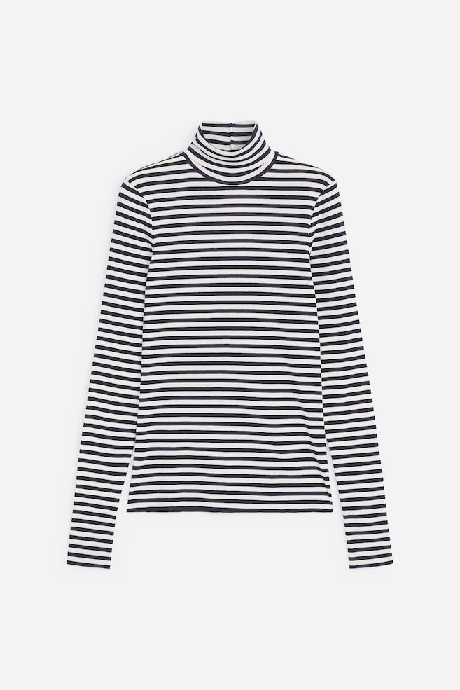 A long-sleeved roll-neck jersey top is shown front-on, displaying a pattern of horizontal black and white stripes. The top features a fitted silhouette, a high folded collar, and long, slim sleeves. - 1