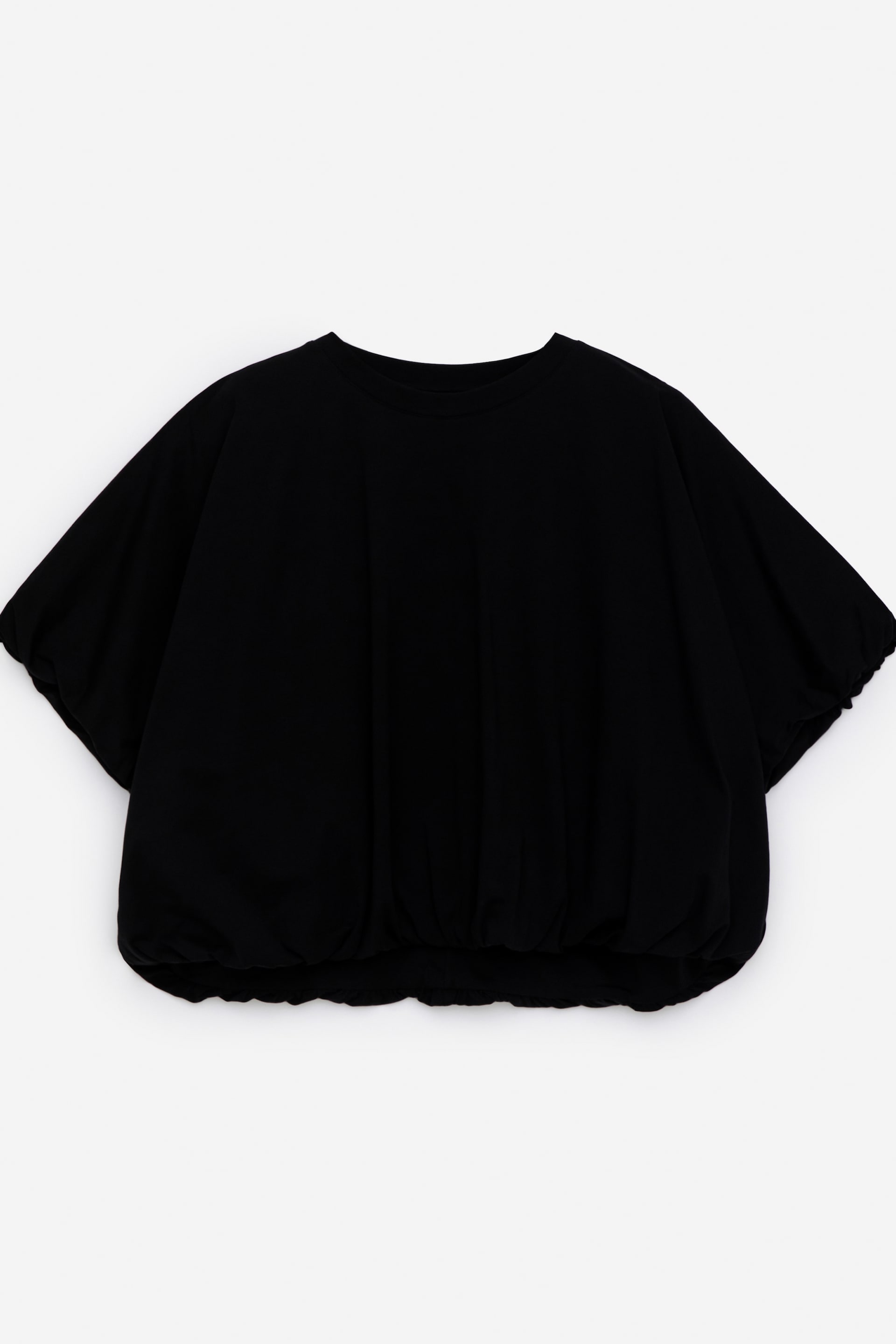 Näytä suurempi kuva: Musta toppi esittää etunäkymänsä, jossa on pyöreä pääntie, lyhyet runsaat hihat, jotka kerääntyvät hihansuihin, sekä löysä vartalo, joka kerääntyy joustavalle helmalle.