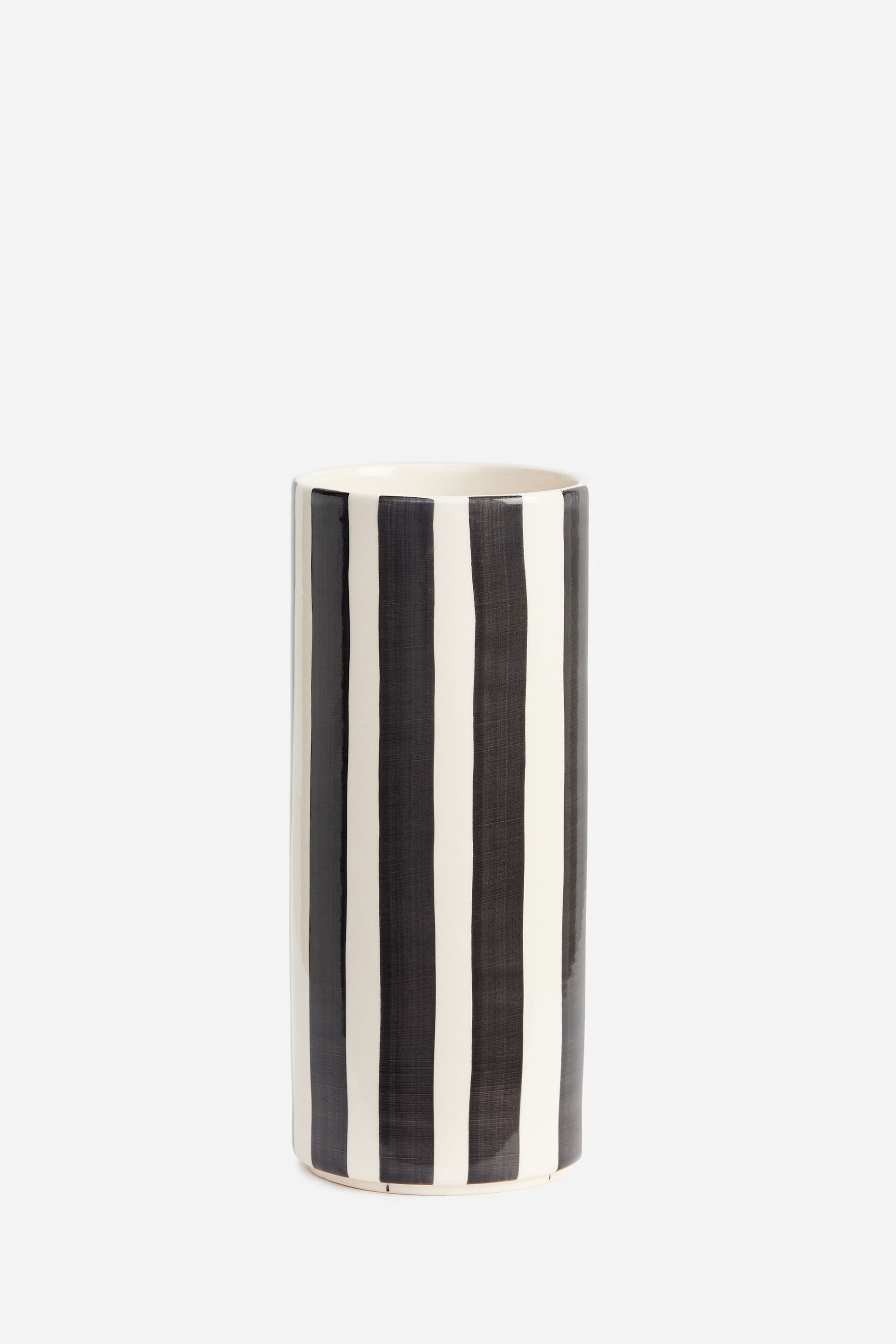 View larger image: A glazed stoneware cylinder vase stands upright, showcasing a pattern of thick, hand-painted vertical black stripes over an off-white base. The vase features a glossy finish and an open top revealing a light-coloured interior.