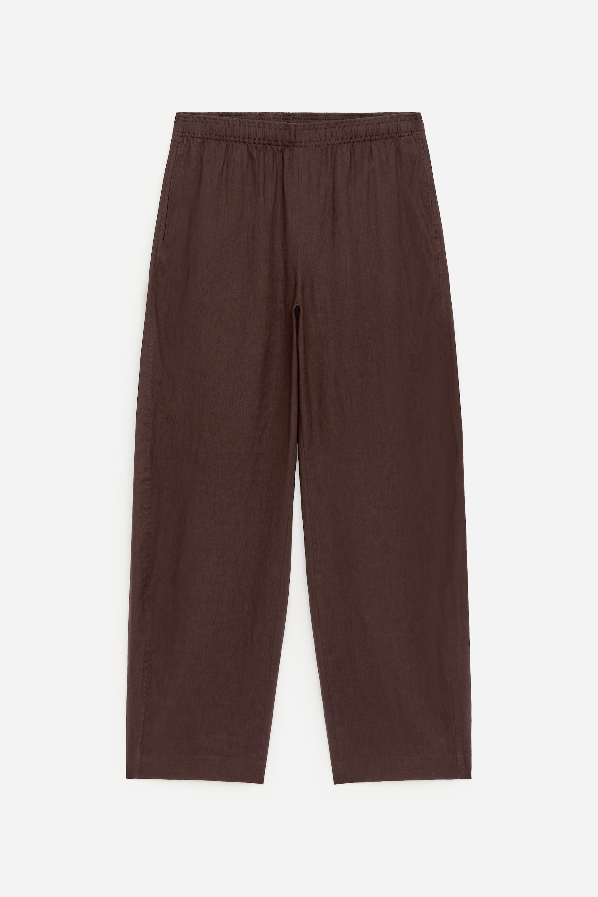 View larger image: A pair of brown wide-leg trousers is displayed front-facing, featuring an elasticated waistband and inset side pockets. The trousers are presented with a straight hem.