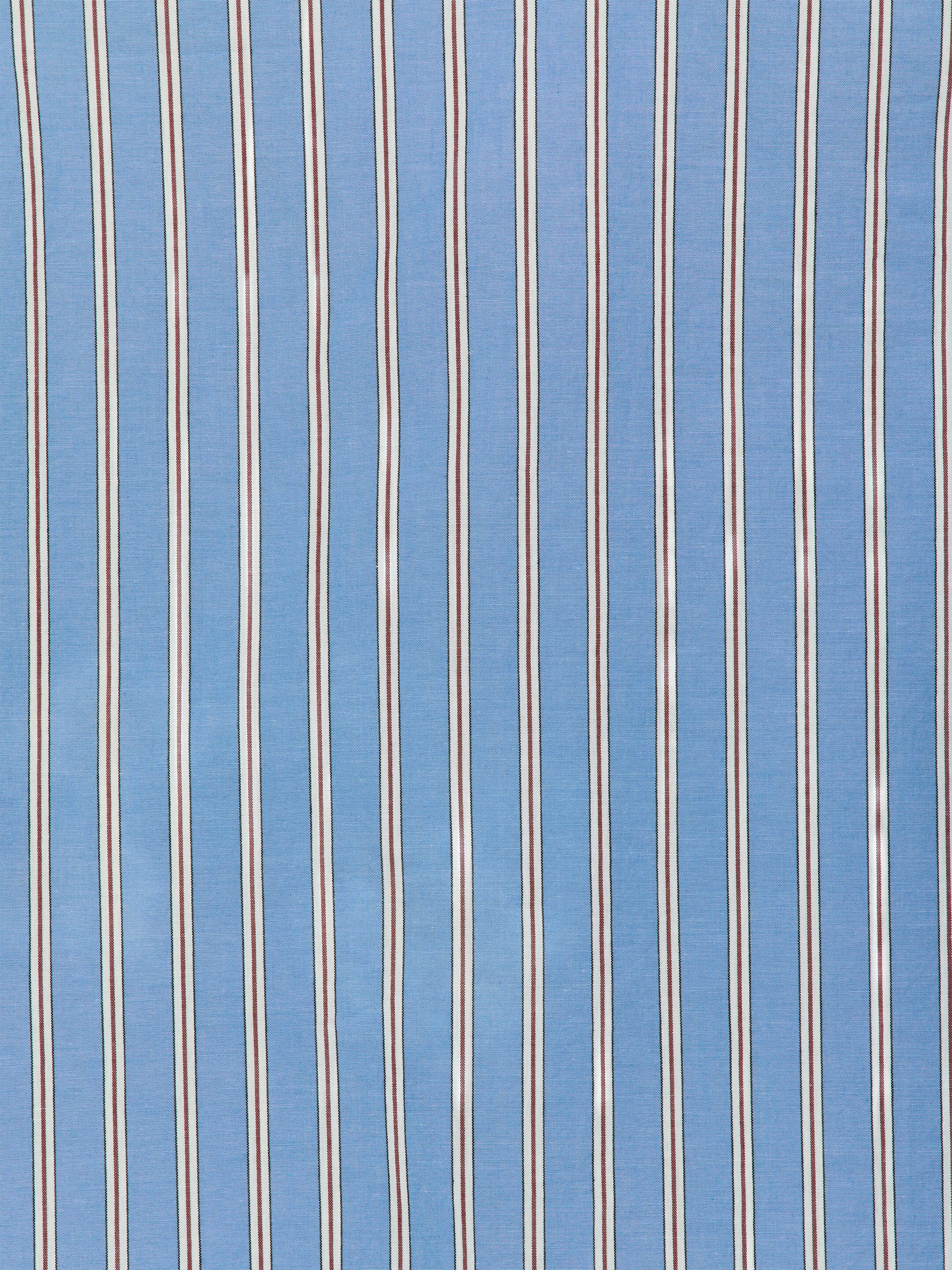 View larger image: Pyjama set with a long-sleeved shirt and trousers, featuring a fabric displaying a pattern of vertical stripes. The design consists of alternating wider light blue bands and narrower triple stripes, each comprising a central brown line flanked by thin white lines and even thinner green lines.