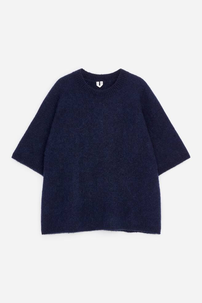 A dark blue short-sleeve jumper is displayed from the front. It features a fuzzy knit texture, a round neck, and a loose fit, with rib-knitted trims at the neckline, sleeve openings, and hem. - 1