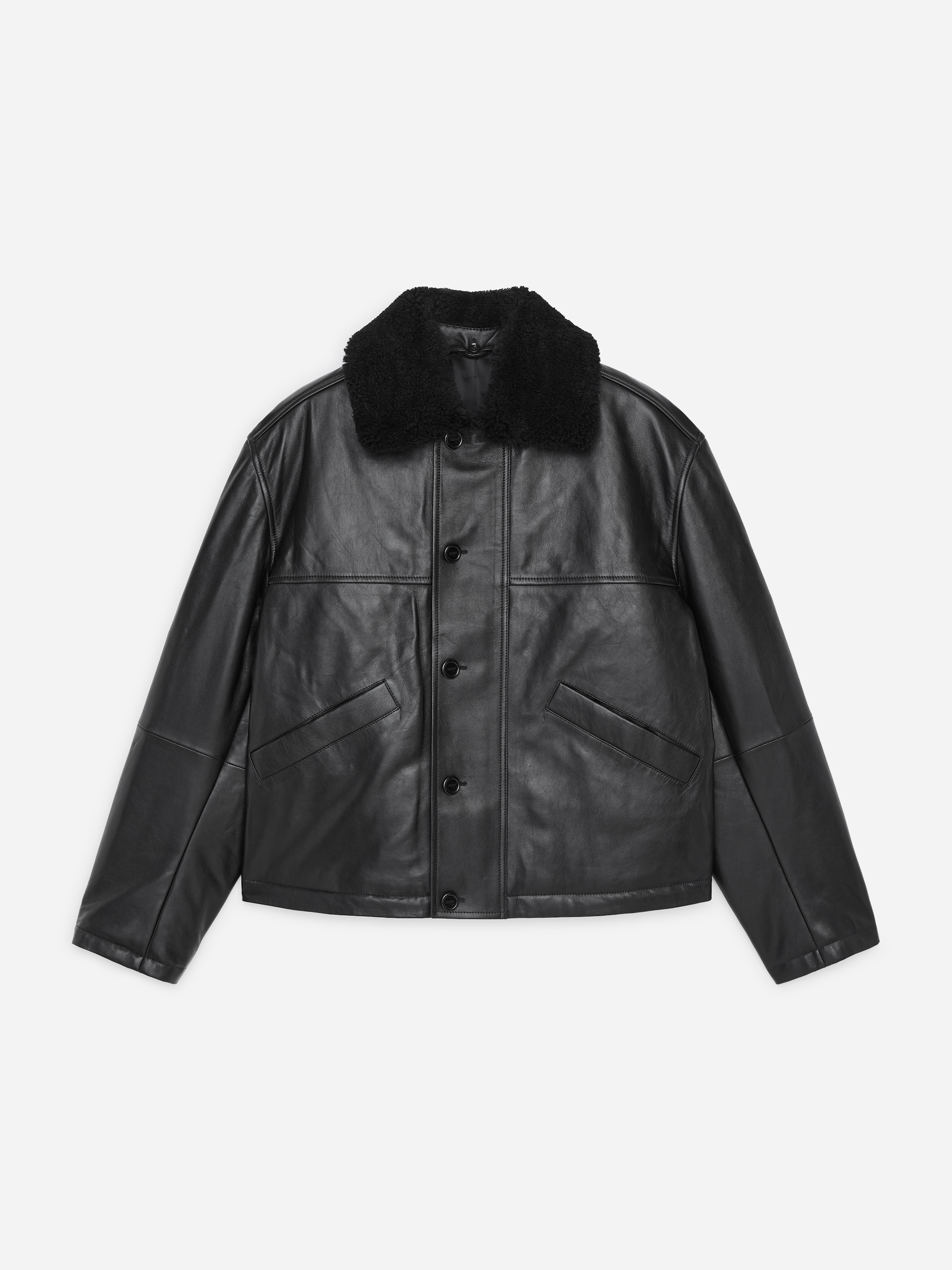 Black leather jacket with a button-up front, flap pockets, and a black shearling collar, displayed on a white background.