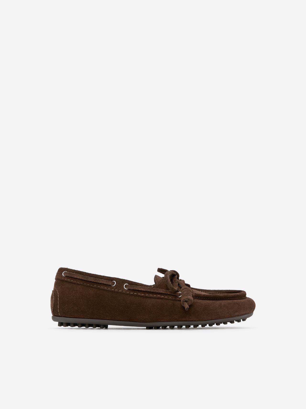 Brown suede moccasin shoe with bow detail, features rubber sole and metal eyelets, displayed on a white background.