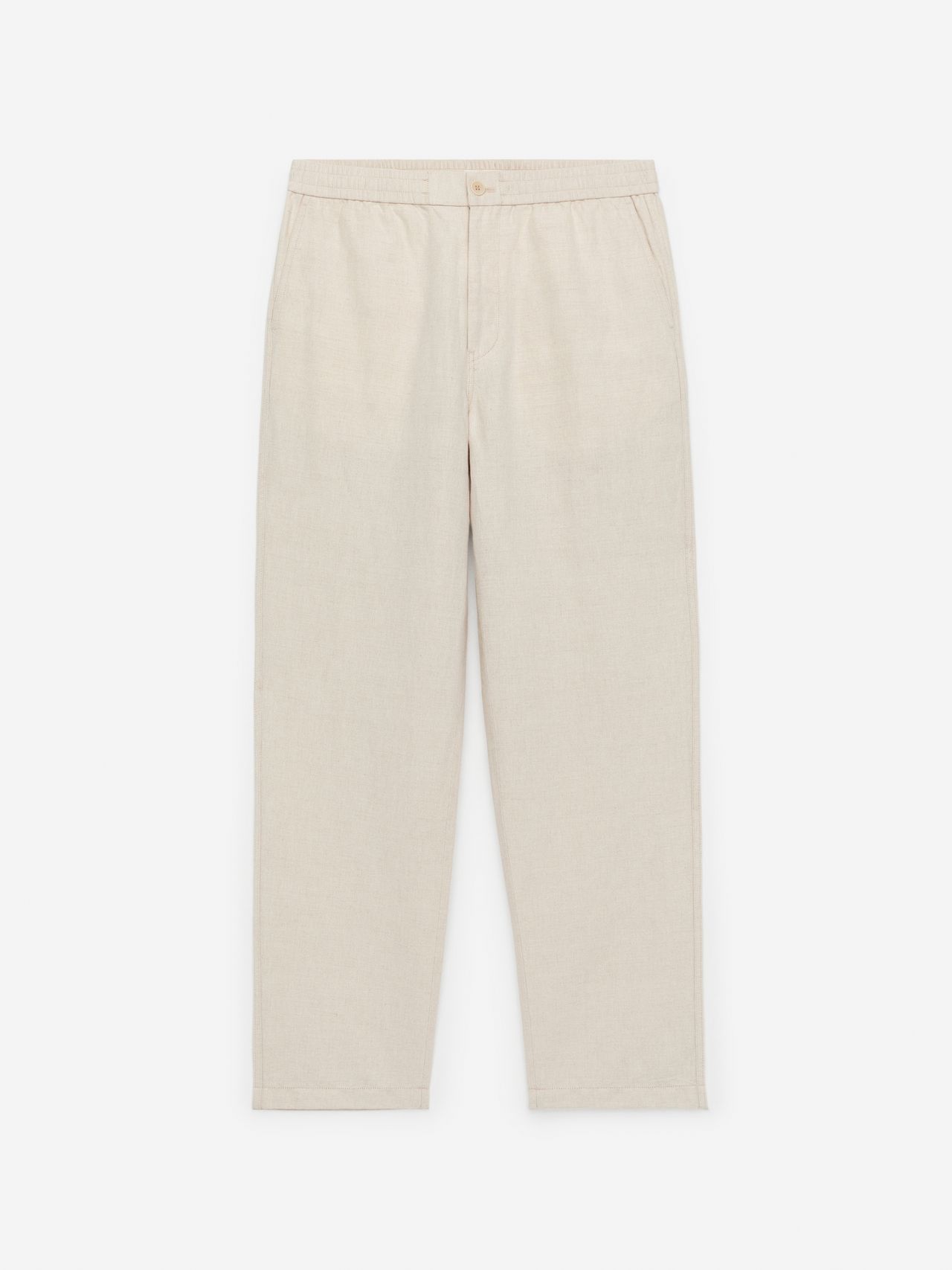 Beige, straight-leg linen pants with an elastic waistband and side pockets, lying flat on a white background.