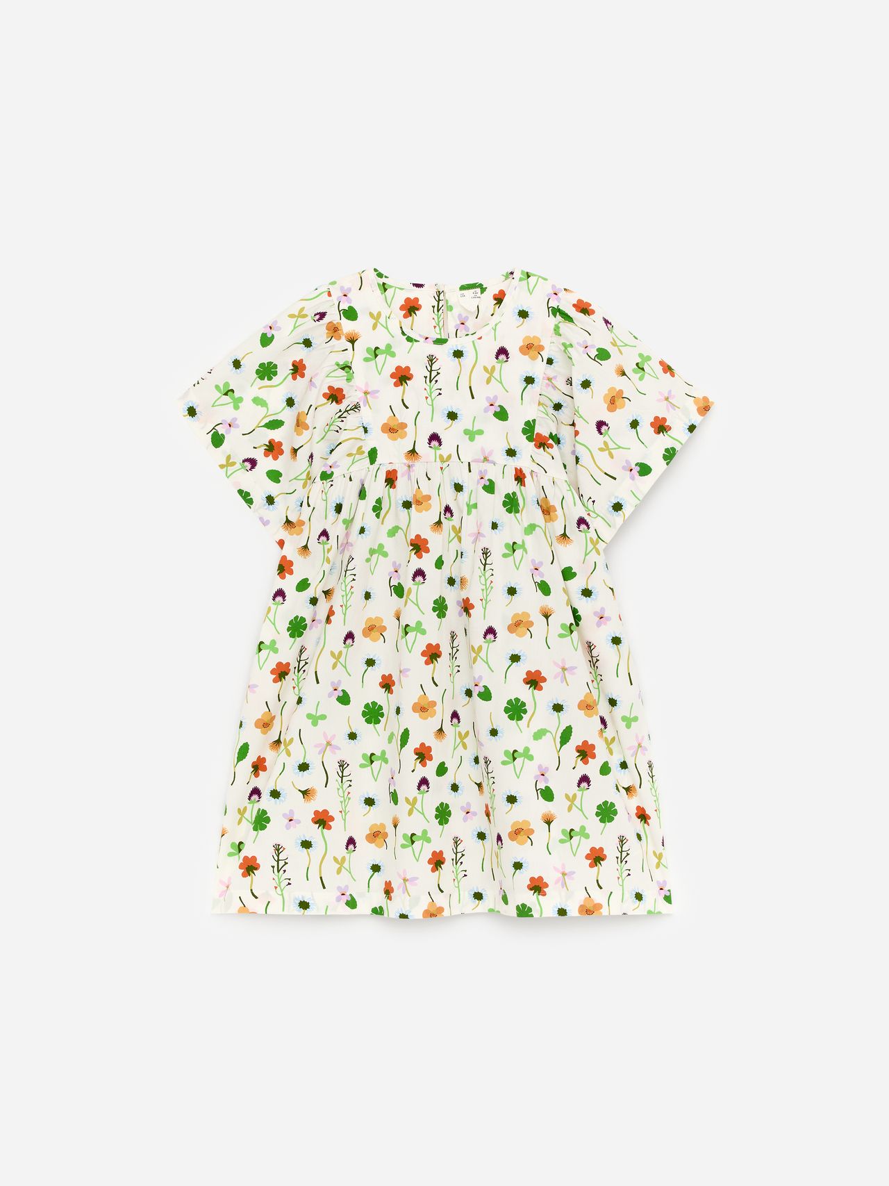 White short-sleeve dress with a colorful floral print featuring various flowers and leaves in orange, green, and purple on a plain background.