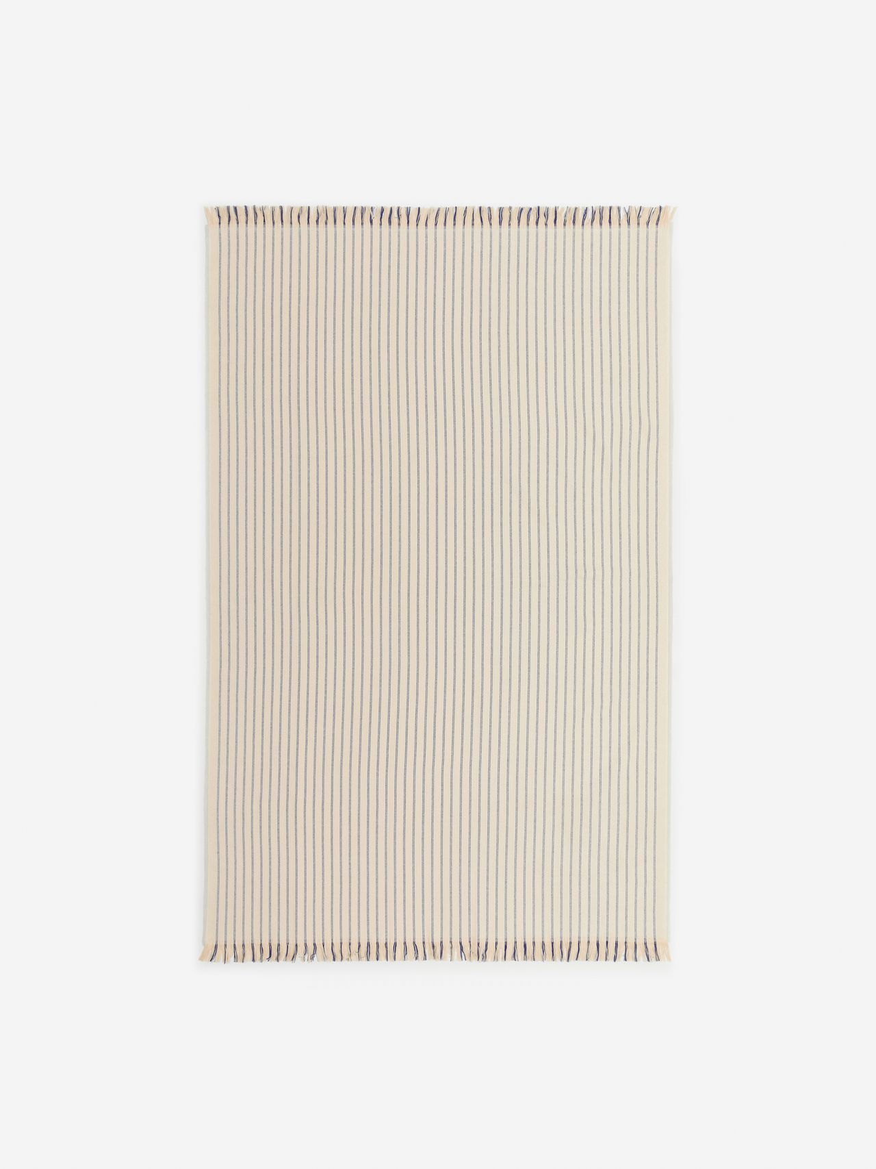 A beige blanket with thin, evenly spaced vertical brown stripes and fringed edges on a white background.