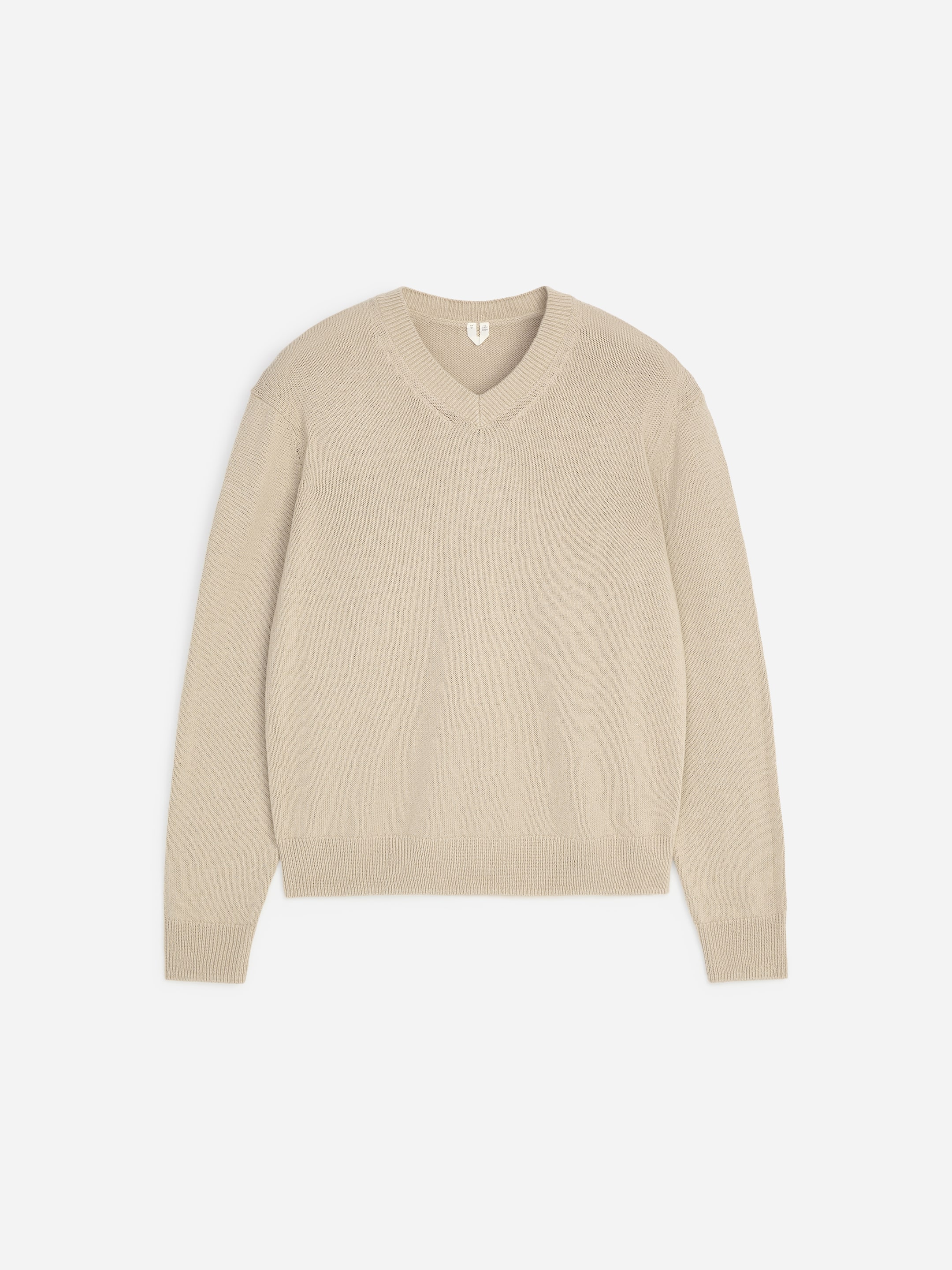 A beige V-neck sweater with ribbed cuffs and hem, laid flat on a white background.