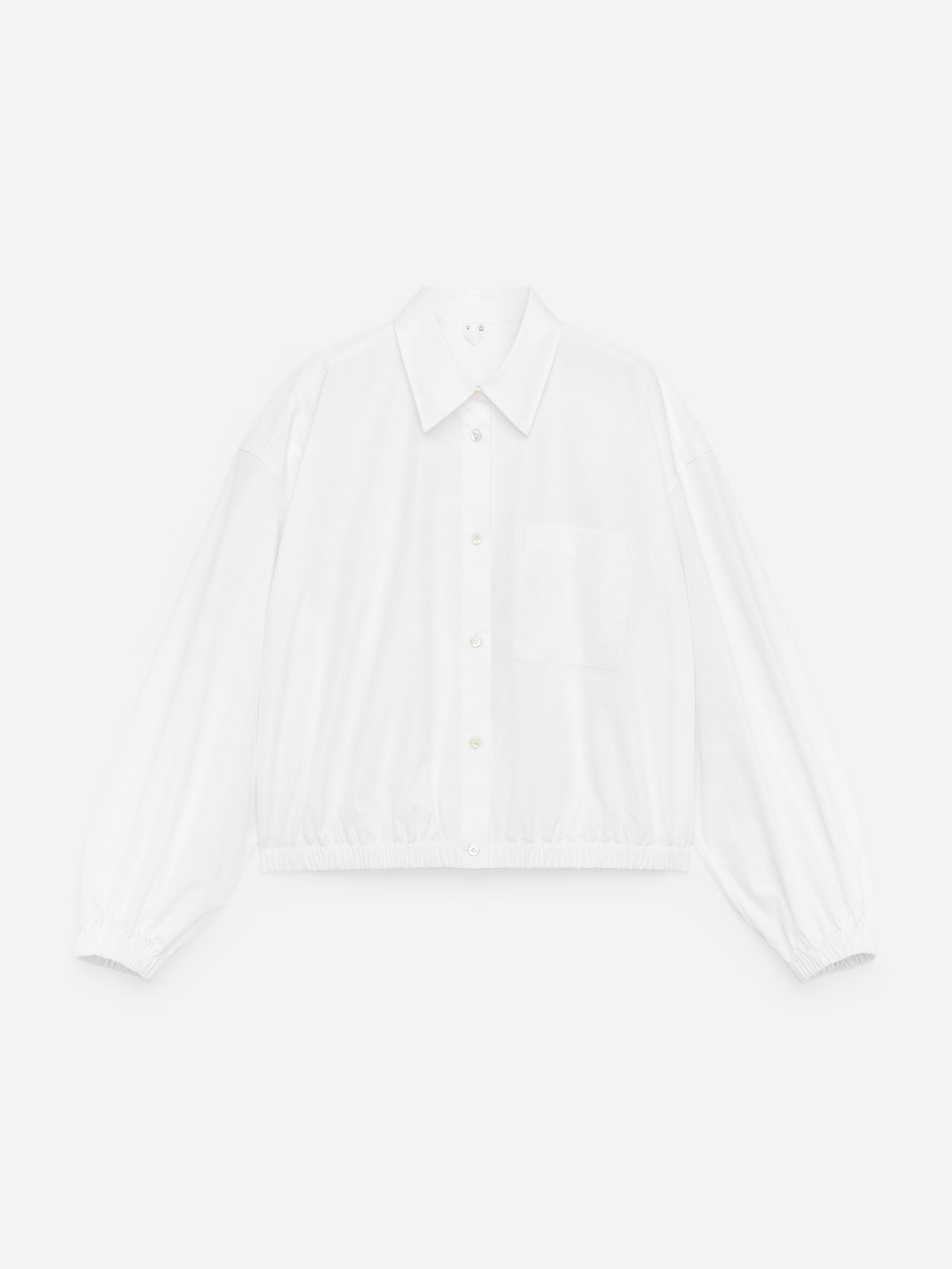 White long-sleeve button-up shirt with a collar, elastic cuffs, and a single chest pocket, displayed on a white background.