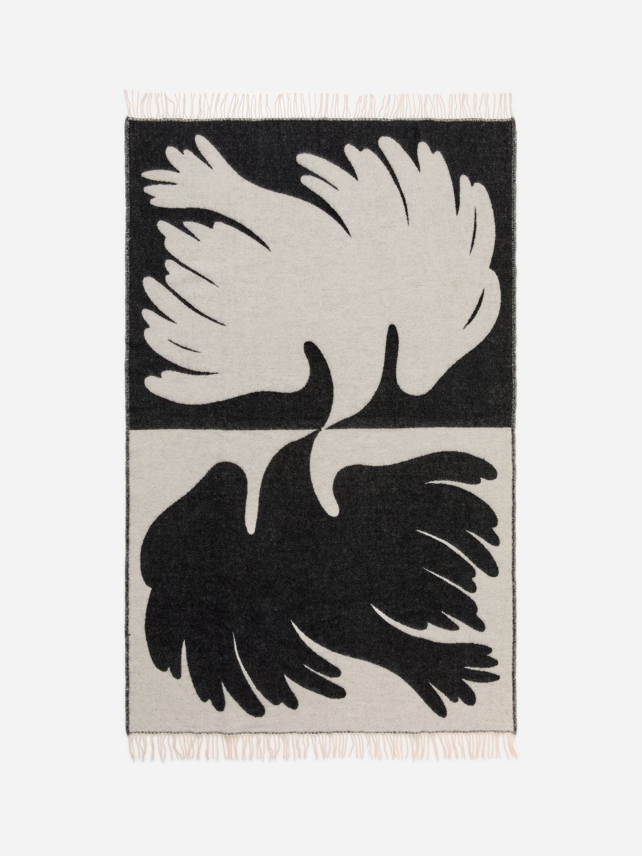 Abstract black and white woven textile with mirrored feather shapes.