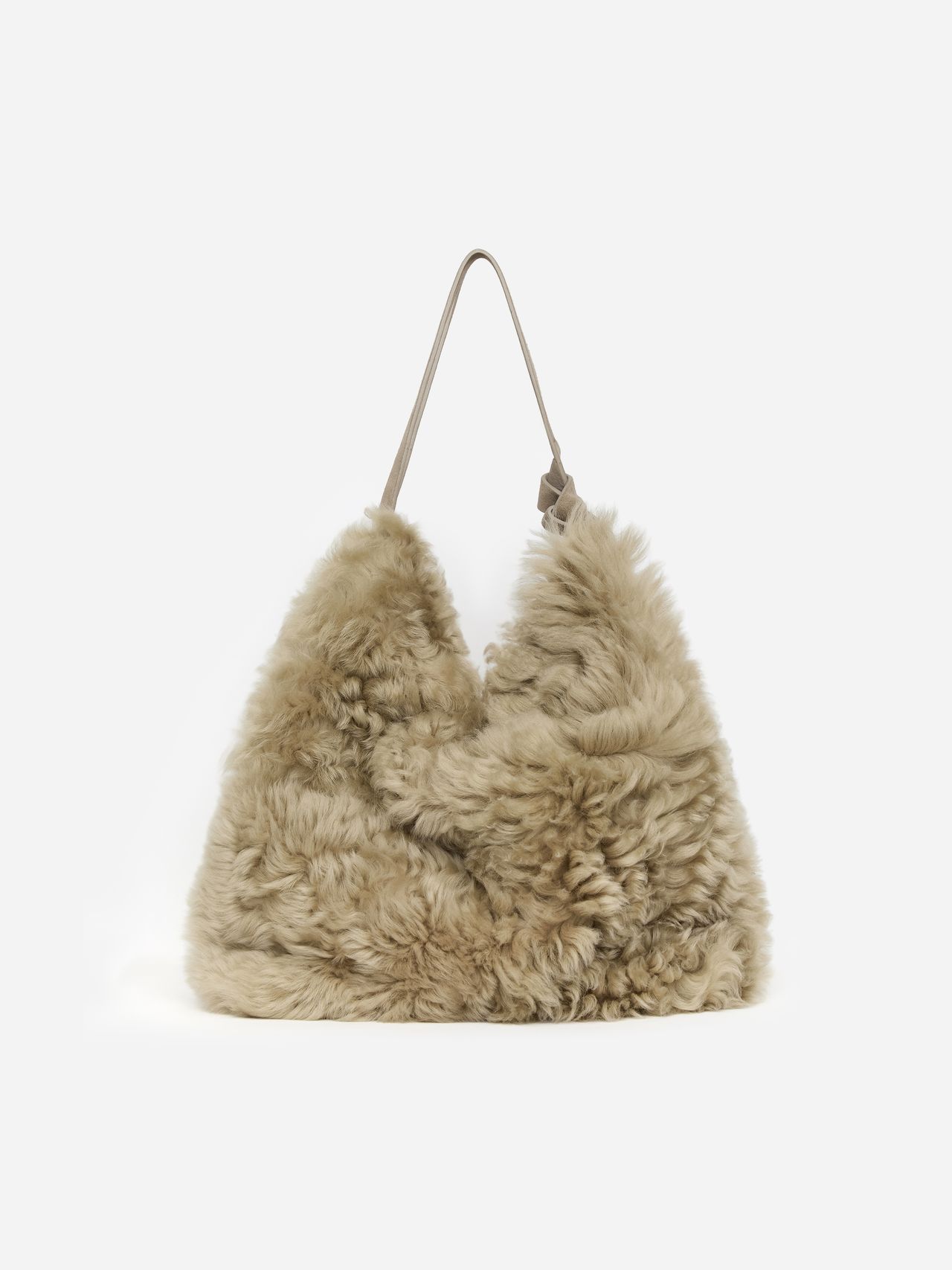 Beige, fluffy shearling handbag with a single strap, featuring a soft, textured surface and a triangular shape against a plain background.