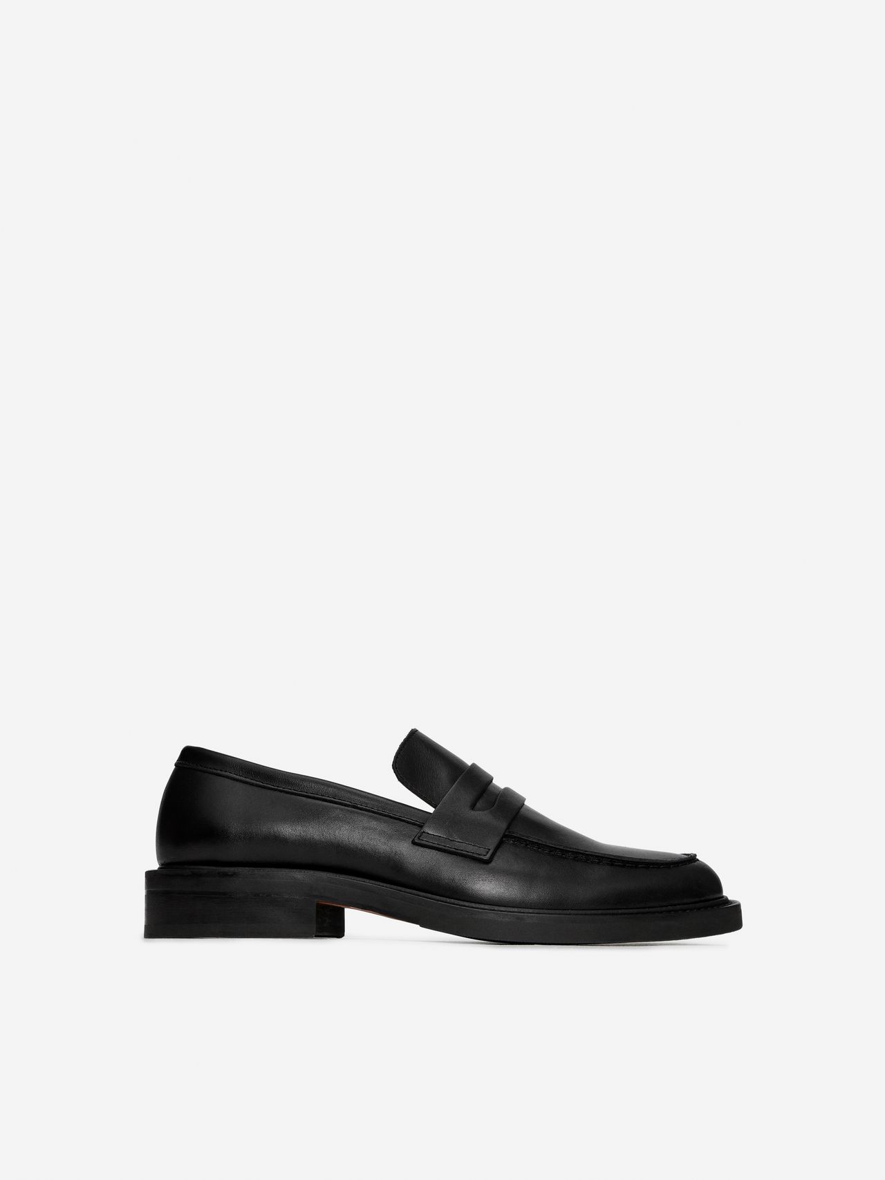 Black leather loafer with a sleek design, featuring a low heel and a classic penny slot detail, set against a plain white background.