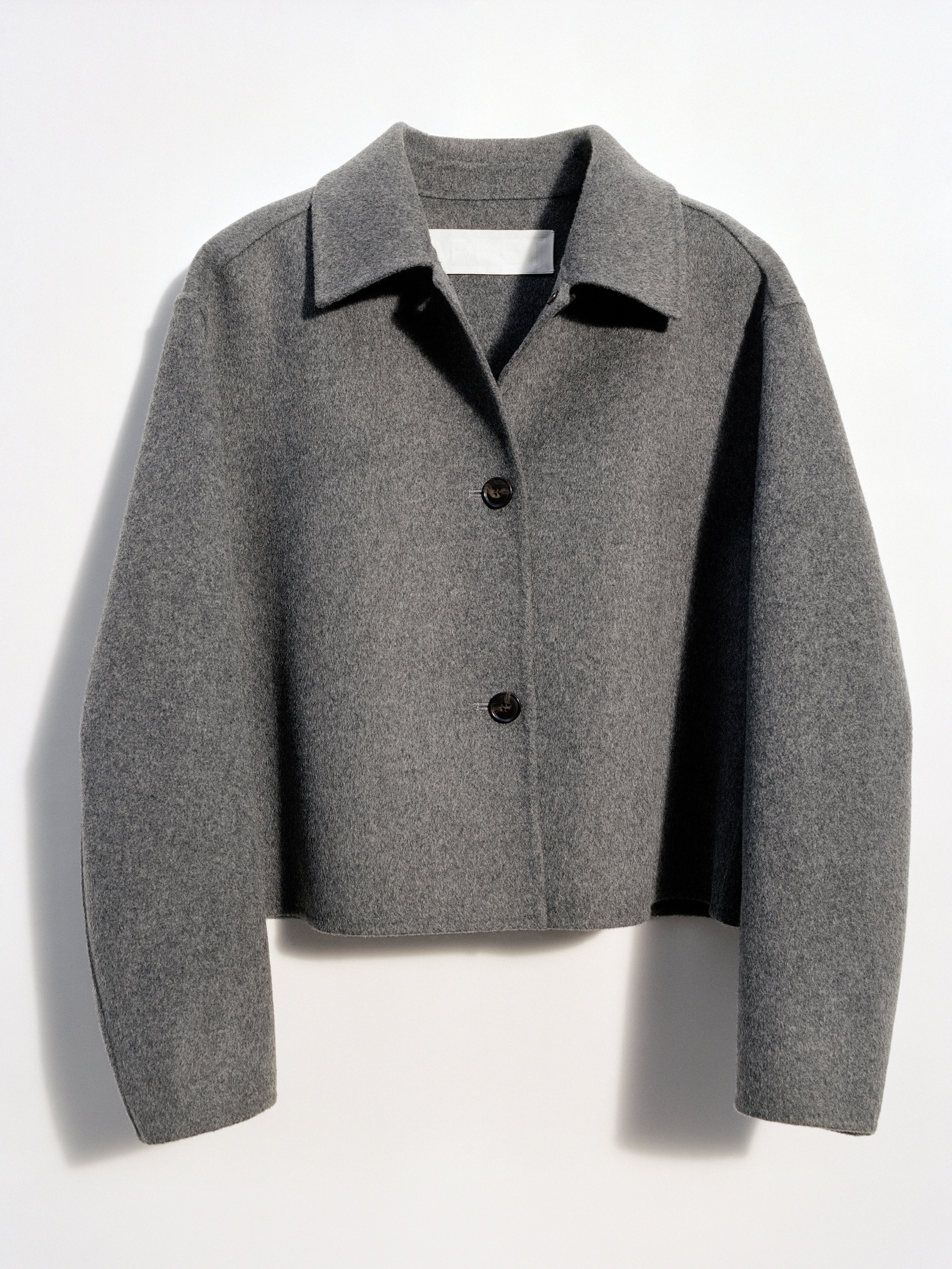 Gray wool jacket with a wide collar and two black buttons, displayed on a flat white background.