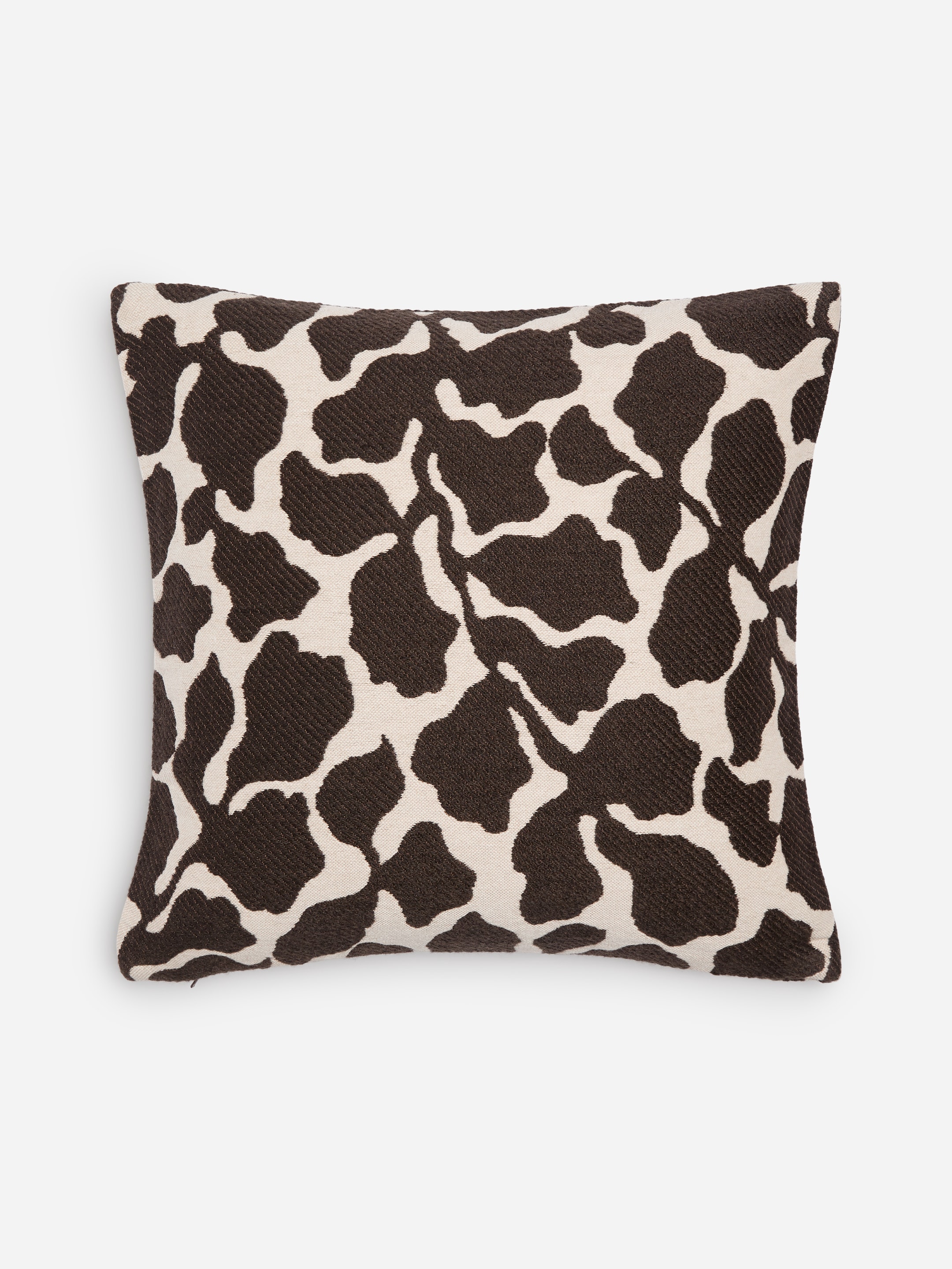 A square throw pillow with a black and white abstract pattern resembling animal print, set against a plain white background.