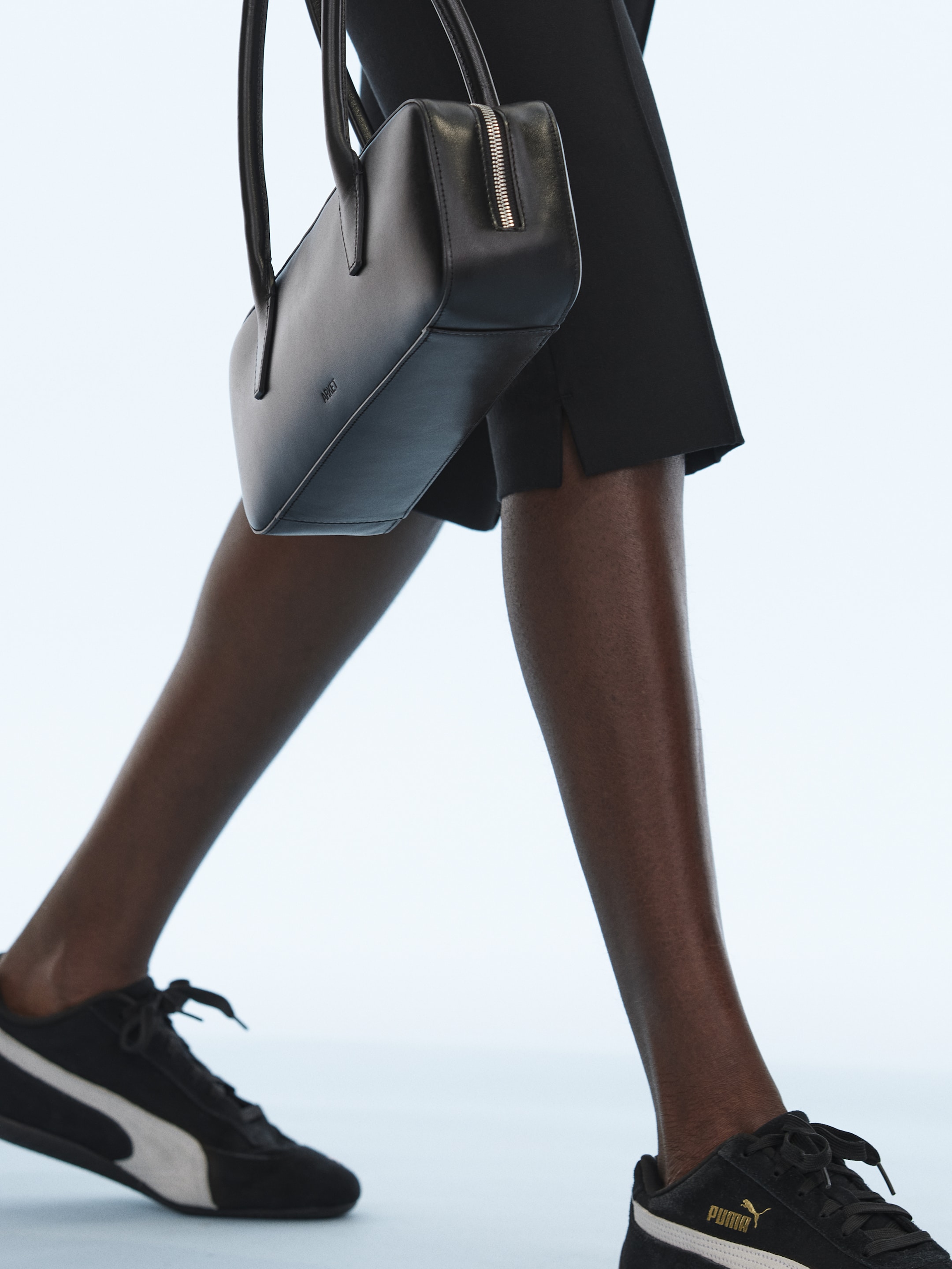 Woman with handbag and sneakers