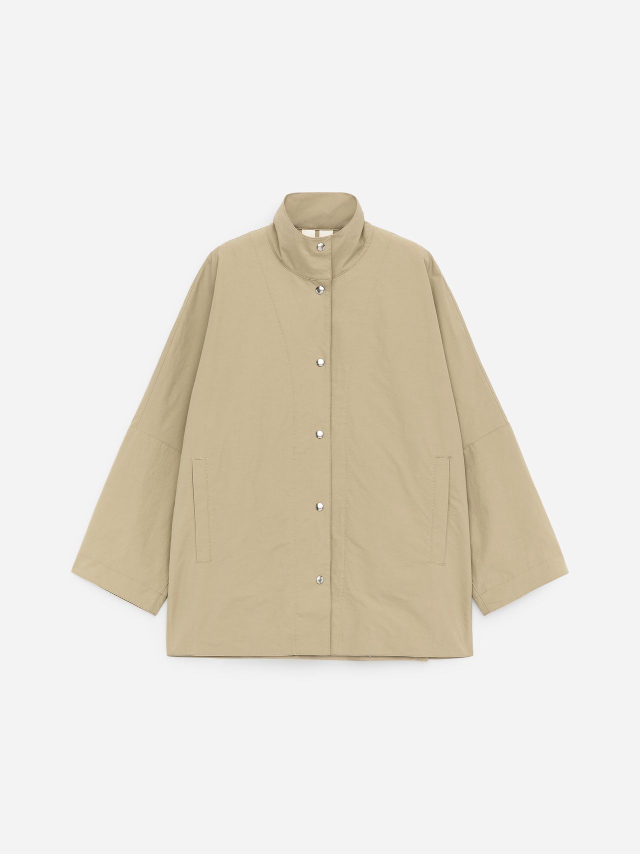 Beige oversized jacket with a high collar, button closure, and two front pockets against a plain white background.